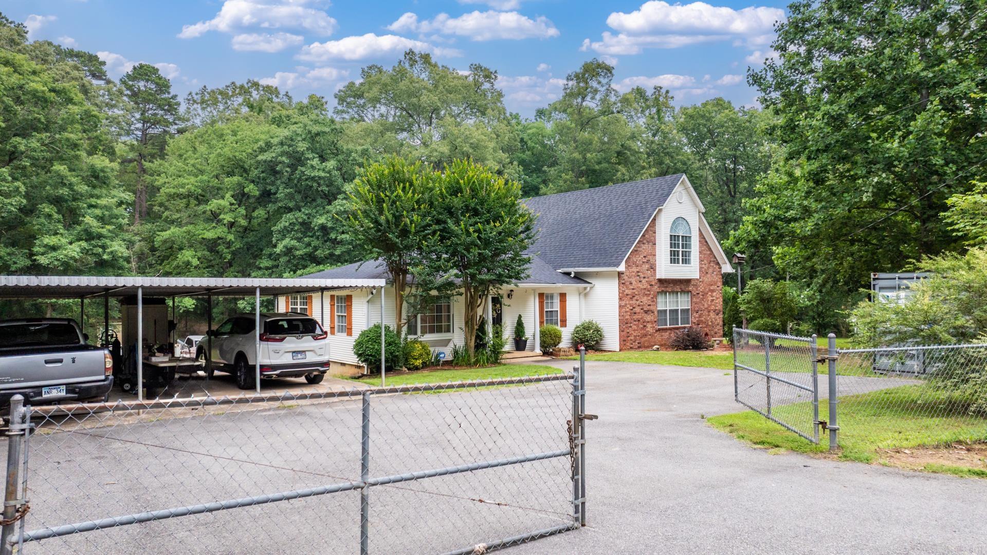 Experience the perfect blend of privacy&convenience in this well maintained home,nestled on 4.71acres just minutes from the interstate.A gated chain-link fence opens to a serene setting w/mature landscaping.The exterior features low-maintenance siding w/brick accents &cedar shutters,complemented by a paved driveway leading to a 3-car covered parking area.The front entry leads to a spacious bedroom/office w/a bay window.The kitchen/dining area boast decorative tile backsplash,ss appliancess,dble windows above the sink & access to a 12'x10' wood deck.An expansive 22'x31' addition offers flex space for dining,den or office,featuring ample windows,decorative(non-functioning)fireplace &dble doors to an 8'x6' deck.Upstairs,the 20'x15' bonus/master suite/game room includes a custom metal design ceiling,wood-lined accent walls,large front window,walk-in closet &full bath w/dble vanity.The basement/workshop area comprises 2 rooms w/concrete floors,block wall perimeters,large windows,electricity &full bath w/stand-up shower &vanity.Additional amenities include a dedicated basketball court/patio area,a14'x18' storage shed,7'x11' storage shed,extended paved driveway/parking pad & French drain