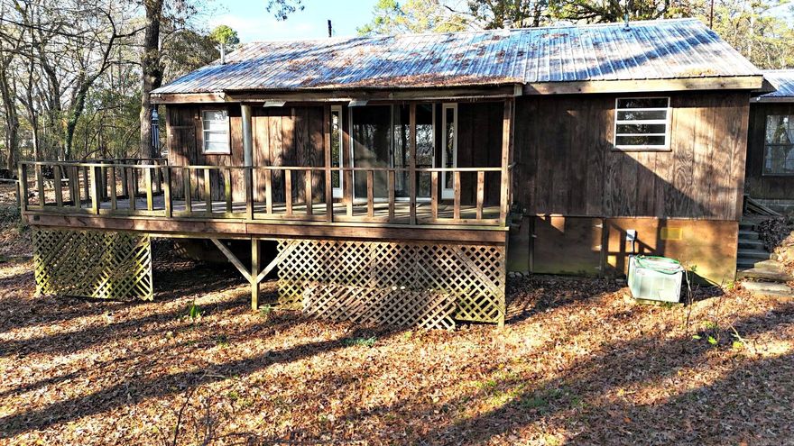 This 2-bedroom, 2-bath home offers a great start for someone looking to add their own finishing touches. Many key updates have already been completed, including a pumped septic system, some updated electrical work, new or repaired flooring, remodeled bathrooms, and partial plumbing updates. The home features charming log siding, inviting decks, and covered porches perfect for outdoor relaxation. Although the property includes two wells, the house is currently connected to city water for convenience. Several outbuildings provide extra storage or workspace, adding to the property’s appeal. Located near McMillan Park, this home combines a peaceful setting with in-town amenities—a great choice for a residence, rental, or investment opportunity.