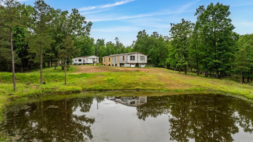 Welcome to the market 159 Roger Wooten. If you're looking for a country setting on 20.06 acres to call home, this is the one. This home features: two mobile homes, pond, options to build (with a separate entrance on Roger Wooten Road), and perimeter fencing. The survey is already completed for you! This property is ready for you to make it your own!   Heat pump and electric NEW 5 Ton 18 SEER Air conditioner, high energy efficiency NEW mini split NEW 60 gallon water heater This place is ready for you to add your finishing touches on the home!  Please confirm measurements windows, door, and exterior siding added