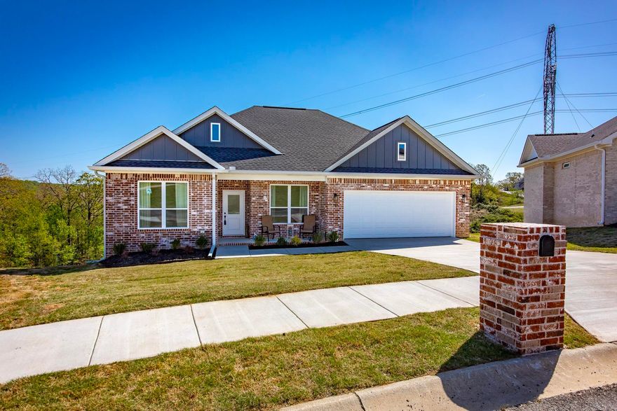 Home built by G2 Contractors.  Many upgrades to include all brick exterior, foam insulation, gutters, and huge yard overlooking the hillside. Three bedrooms and 2 1/2 baths, which is so convenient for guests!  Love the center island with space for six bar stools!  Soft painted trim and cabinetry for soothing relaxation!  Cool electric fireplace that has changing fire colors. Stainless steel appliances and luxury vinyl flooring throughout makes this an easy care home!  The custom tiled walk in shower will be your favorite place in the primary bathroom! Refrigerator, washer & dryer stays! Oversized deck overlooking mother nature! No back yard neighbors!  Builder warranty until Oct 2026. See agent notes.