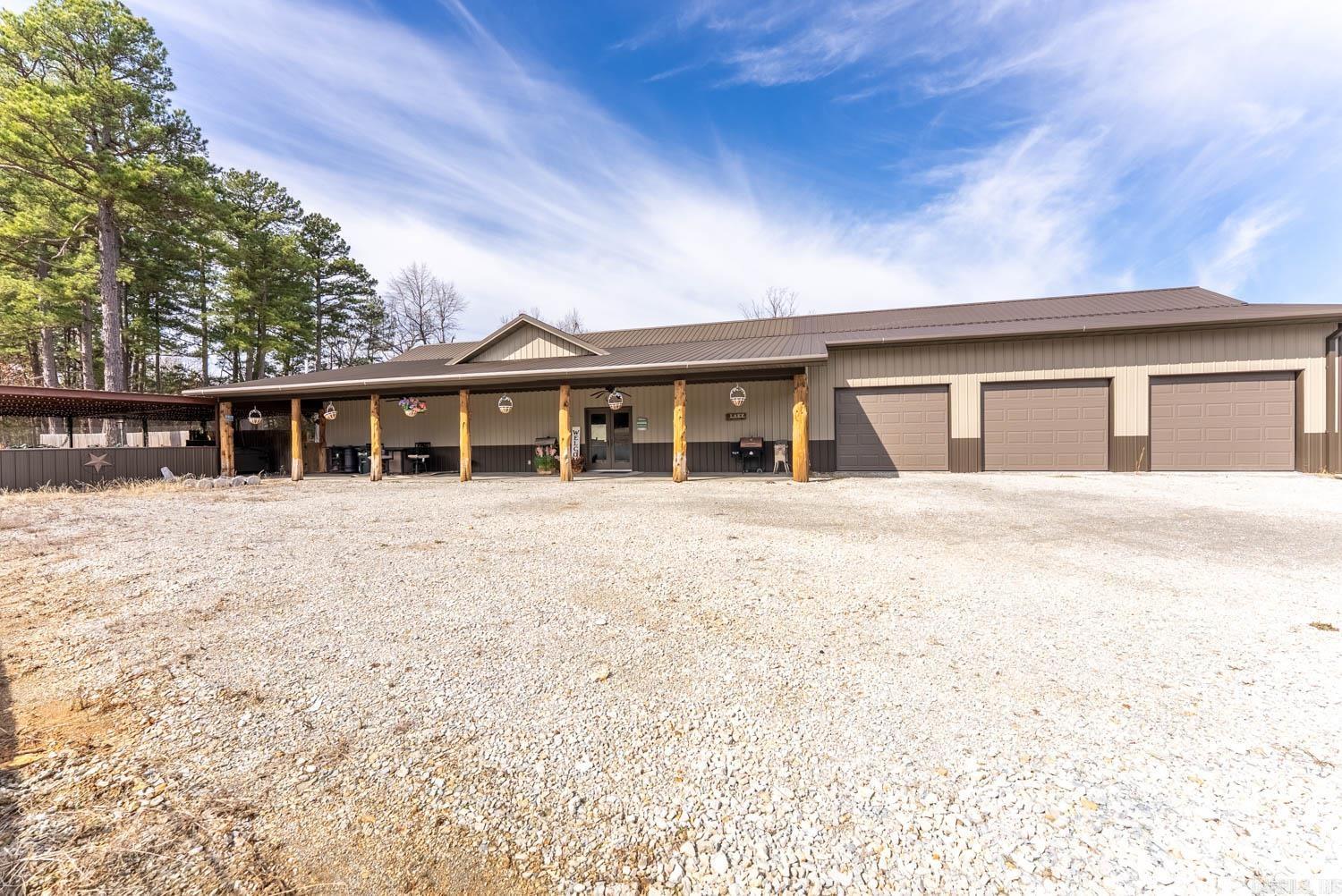 Lakefront living meets wooded seclusion on this 32-acre Fulton County, Arkansas property featuring a custom-built 2-bed, 2-bath home. Enjoy an open-concept layout with large windows overlooking a private, stocked lake filled with crappie, bass, and bluegill. The spacious master suite is a true retreat with exterior access, double vanities, jetted tub, walk-in shower, and walk-in closet. The home is fully accessible with wide hallways and doors. A 3-car garage includes a concrete storm shelter/safe room. Outside, a 40x40 shop with 15-ft lean-to offers ample space for equipment or toys, while the fenced backyard adds privacy. Relax or entertain at the covered outdoor living space with bar, stone fireplace, and hot tub. This wooded haven is perfect for hunting, fishing, and outdoor recreation. Located just 8 minutes to Lake Norfork access and 15 minutes to Mountain Home, this property offers the best of both convenience and nature.