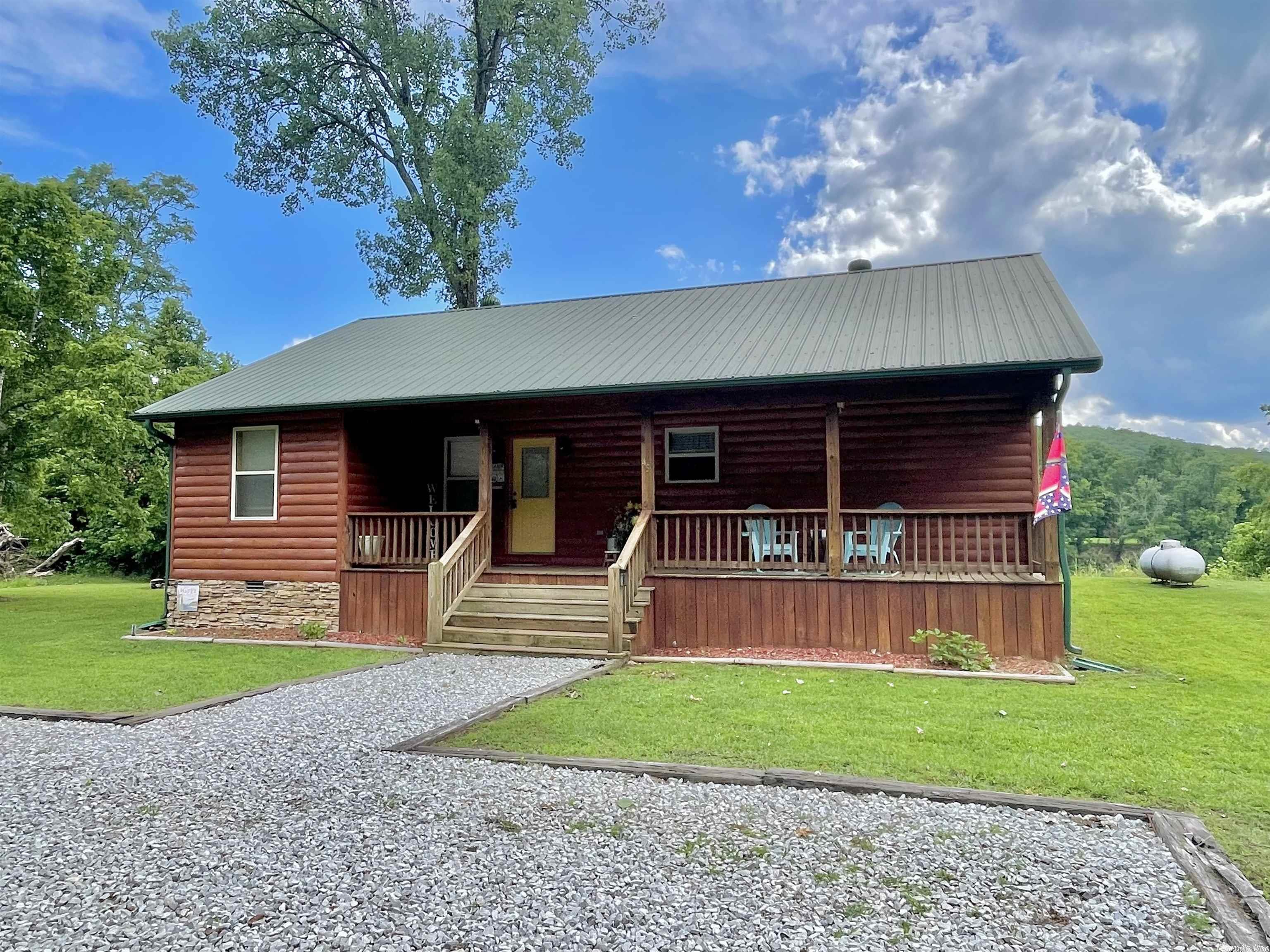 WHITE RIVER CABIN IN THE MOUNT OLIVE COMMUNITY!! This 3 bedroom/2 bath cabin features a spacious living area with vaulted wood ceilings, gas fireplace, & large windows for a great view of the River. The kitchen area has lots of counter top & storage space and is open to the dining area. The master bedroom offers 3 closets, one being a walk in, and a full bathroom. Outside the home is a large back deck great for grilling and family gatherings! This home is the ideal vacation spot or weekend rental! Located near the National Forest where there are hiking trails & Arkansas Game & Fish Boat Access! Don't miss your chance to own an affordable cabin on the Famous White River! *Agent Owned*