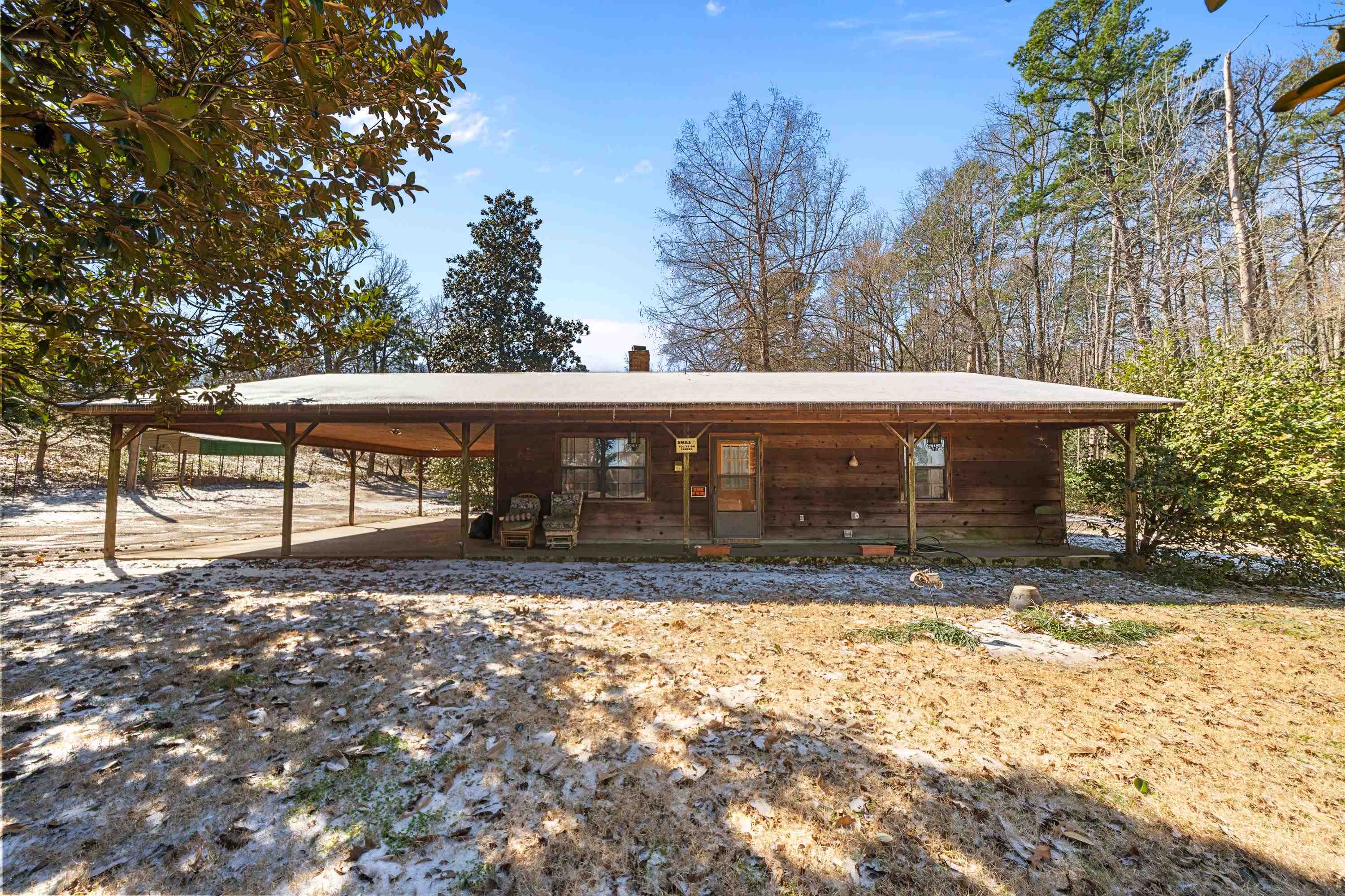 Escape to your own private paradise with this charming country home. It sits on almost 6 acres of serene, tree lined land. You will love the space and privacy this home has to offer. The open floor plan featuring a large wood burning stove makes for great family/friends gatherings. The welcoming front porch is perfect for your morning coffee or to unwind in the evening. Outside the possibilities are endless, featuring a large barn with stalls ready for livestock, hobbies or additional storage. There is also a separate shed which offers wood and tool storage. There is also a large covered parking for an RV or a boat. There are mature trees on the property as well as a great gardening space. With so many possibilities this is one you will sure want to see.