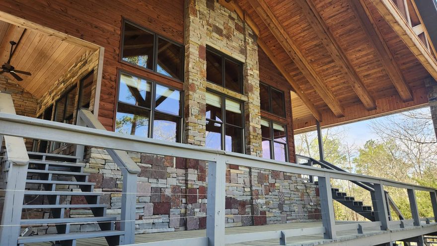 12.6 acres less than a mile to Lake Ouachita/Ouachita River features a "main house" (built in 2015) with 2540 sq ft living space. Vaulted ceilings, Pella windows, 16x22 sunroom, office, 2 bed 2 bath with heated floors, 2 sided fireplace, safe room. Outdoor kitchen includes Big Green Egg. "Guest House" 32x21, 2 bedroom 1 bath, kitchen appliances convey (including dishwasher). 19x15 tool shed, 40x16 insulated metal boat/storage shed, "Man Cave" 32x21, "Barn" 42x20. There is also a stocked pond. This property is somewhat secluded and easy to maintain. The exterior rock work adds a natural concept to this unique property, concrete driveway, and 24KW Generac  generator.