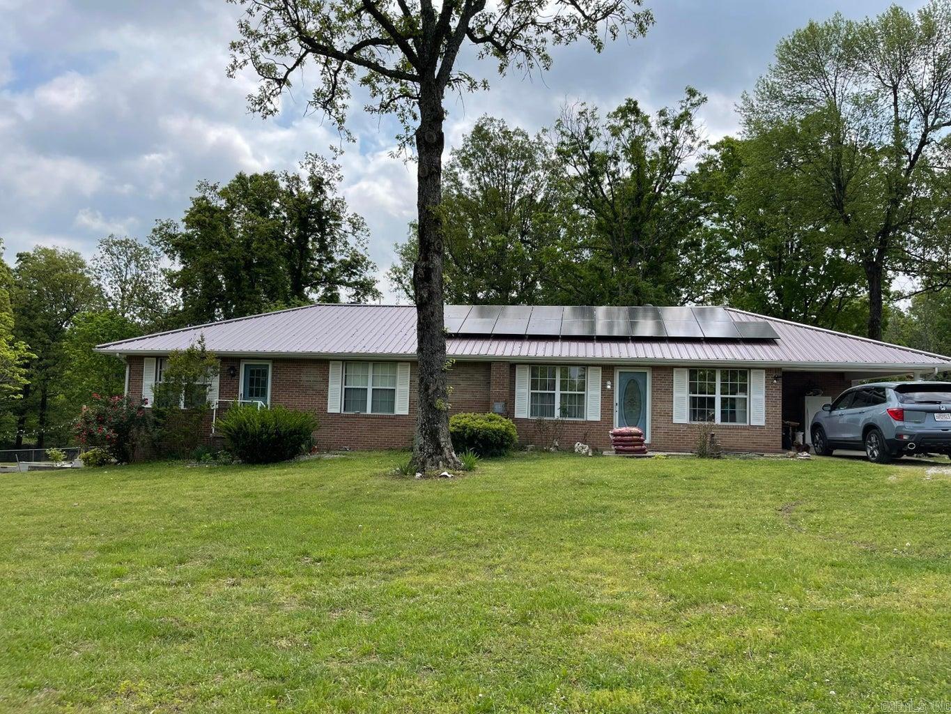 Mini farm with well maintained 3 Bedroom, 3 Bath, brick home on 5 un-restricted, fenced, cross fenced acres with pond located less than 4 miles from Ash Flat. Home features walk out basement, dedicated laundry, office which could be a 4th bedroom, new kitchen, flooring, metal roof new in 2018, new HVAC installed in Dec 2019, new solar panels in 2021, and privacy fencing along highway. Large back deck with a 16 X 32 above ground pool that's perfect for backyard living! Extra storage in the detached garage/ shop, along with the 10 x 16 Bald Eagle Barn She Shed. There is a 40 X 40 barn for livestock or hay with electric and water. Chicken coops already established and fenced areas for them as well as your fur babies.