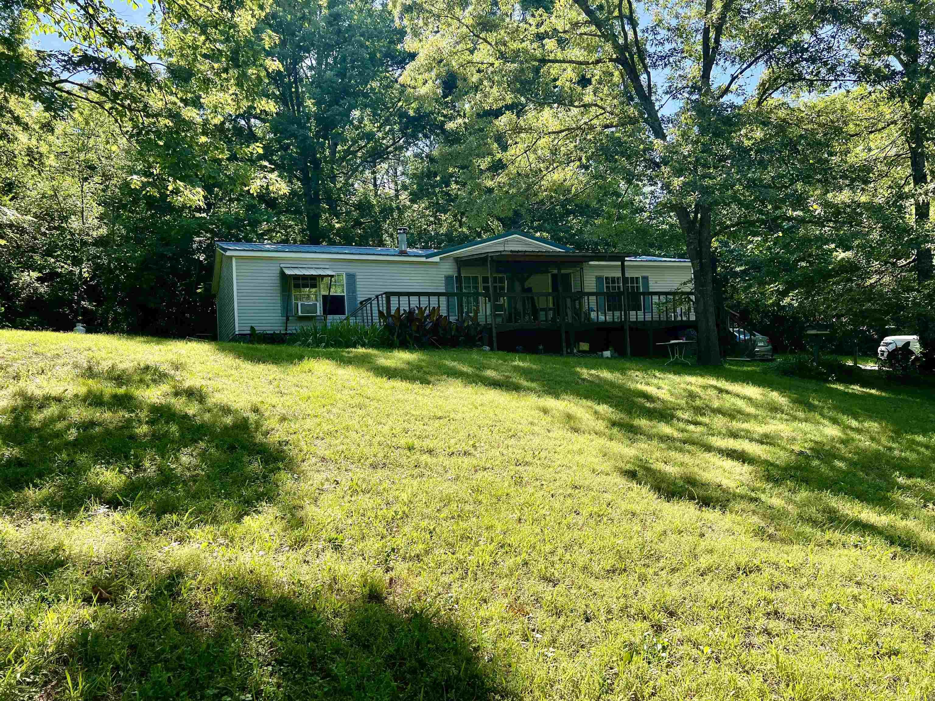 Located in the highly sought-after school district , this charming 3-bedroom, 2-bath home near Lake Hamilton offers the perfect blend of comfort and rustic charm. Seting on 2.03+/_ acres secluded lot with large timber. The property features a small creek, durable metal roof, a backup Lifan generator, and a cozy wood-burning stove. Make your appointment today!