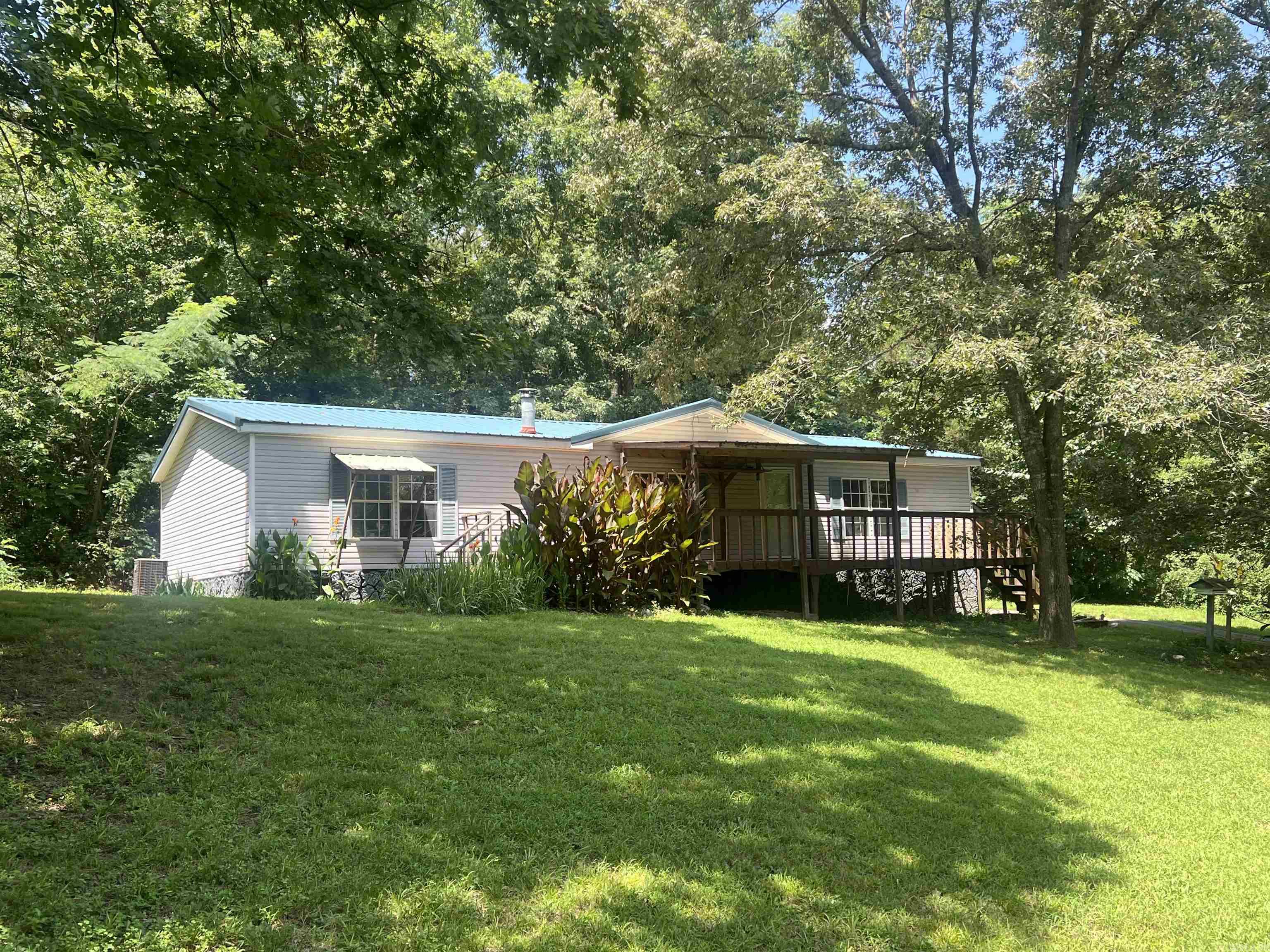 Located in the highly sought-after school district , this charming 3-bedroom, 2-bath home near Lake Hamilton offers the perfect blend of comfort and rustic charm. Seting on 2.03+/_ acres secluded lot with large timber. The property features a small creek, durable metal roof, a backup Lifan generator, and a cozy wood-burning stove. Make your appointment today!