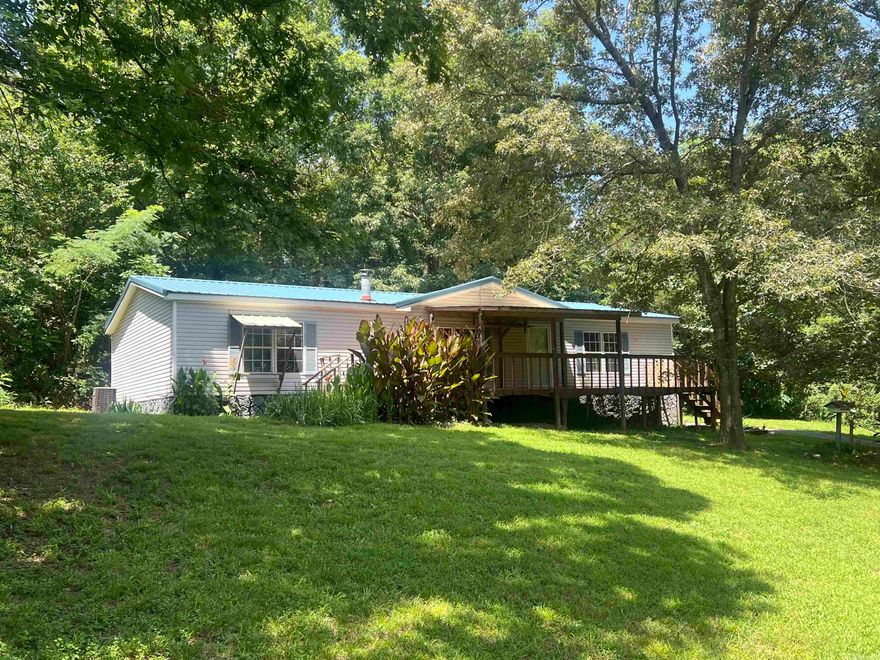 Located in the highly sought-after school district , this charming 3-bedroom, 2-bath home near Lake Hamilton offers the perfect blend of comfort and rustic charm. Seting on 2.03+/_ acres secluded lot with large timber. The property features a small creek, durable metal roof, a backup Lifan generator, and a cozy wood-burning stove. Make your appointment today!