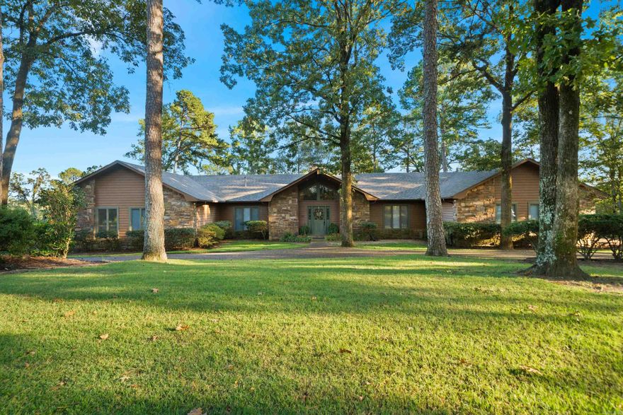 Welcome to 214 Whispering Hills Street, an exceptional property nestled on a spacious one-acre lot in the highly sought-after Eastgate II subdivision in Hot Springs, Arkansas. This beautifully maintained residence offers a perfect blend of elegance, comfort, and functionality, making it ideal for families and those who love to entertain. Boasting four generously sized bedrooms, three full bathrooms, and two additional half baths, the home provides ample space for both everyday living and hosting guests. Inside, you'll find multiple living areas thoughtfully designed to accommodate a variety of lifestyles, from quiet relaxation to lively gatherings. The home's exterior is equally impressive, featuring mature landscaping that enhances its curb appeal and adds a sense of privacy and serenity. The outdoor spaces are a true highlight, offering expansive, recently updated decks perfect for entertaining, or simply enjoying the beautiful natural surroundings. A recently replaced roof adds both value and peace of mind, while the overall condition of the home reflects attentive care and pride of ownership.