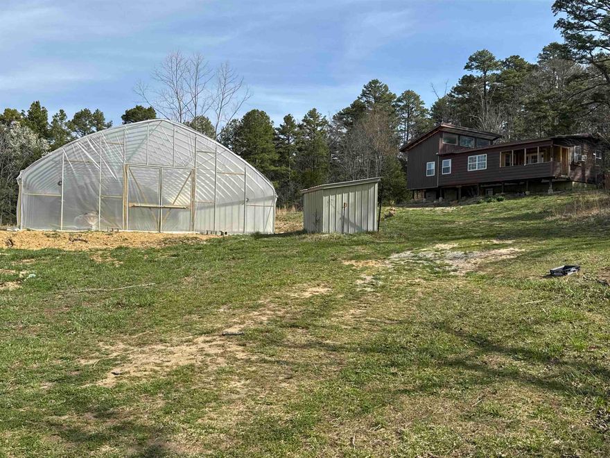 Grow Your Own Lifestyle – Ozarks Property with Live Water and Large Greenhouse  This 2 bedroom, 2 bath home on approximately 2 acres offers peaceful country living and plenty of potential. This home does need some finishing, giving you the chance to make it your own. A walk-out basement adds extra space and future possibilities. Live water runs through the property, and it’s well-suited for a self-sustaining lifestyle. Grow your own food in the outdoor garden or in the brand-new high tunnel greenhouse. There’s room to feed a head or two of livestock, plus an older home that could serve as a workshop or storage, along with additional small outbuildings.