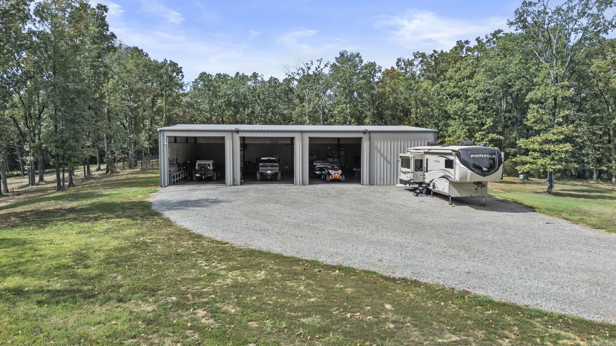 Work here, play here, live here! This one-of-a-kind barndominium sits on 12.77 acres just minutes from the city limits of Searcy offering approximately 1920 sq ft of H/C living space, 4800 sq ft of insulated H/C shop space.This red-iron building perfectly blends, comfort and function. Inside its all about the details-crown molding, custom cabinetry, wall ovens built-in grill, spa-style shower. Outdoors, you'll find an in-ground pool, fenced yard and an 8 x 12 storage building with electric. Perfect for downsizing or retirement living, with space to expand if desired. Private and peaceful setting close to everything.