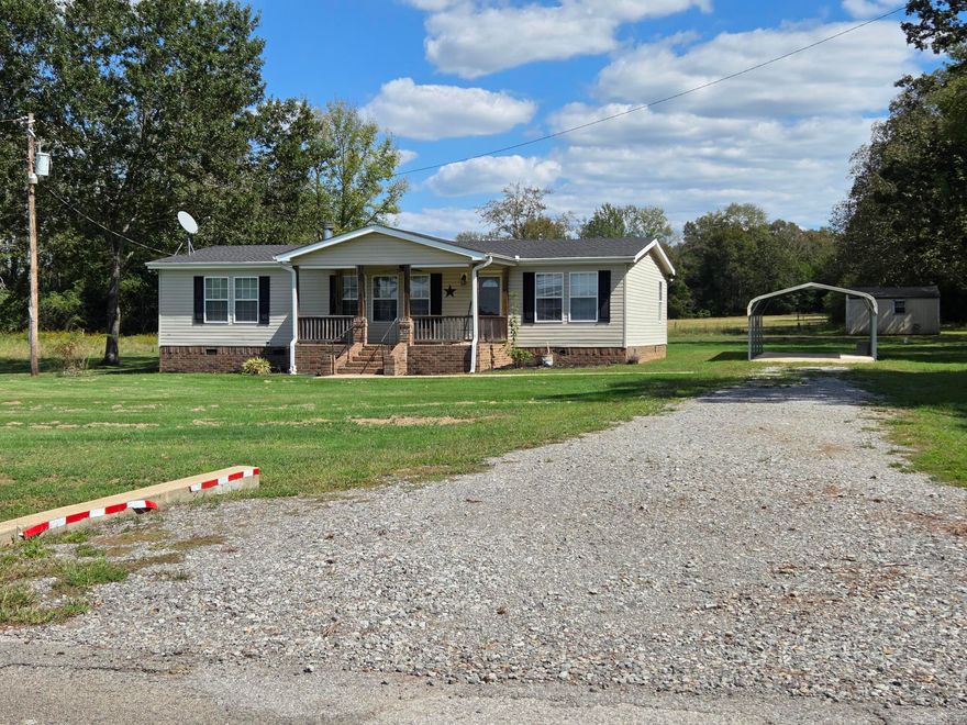 Very nice double wide on permanent foundation with 6" sheetrock walls & ceilings on 2 acres just a few miles northwest of Searcy. Nice level land, 2 car detached carport, storage building, large back deck & covered front porch with swing. Inside you will find a foyer, open floorplan with fireplace in the living room & a kitchen with a long breakfast bar & pantry. The primary bedroom has an attached spacious bathroom with a garden tub, standup shower, double sinks that has an exterior back door. The added sunroom has a Mini split & wrap around windows for relaxing but could be used as a game room, 4th bedroom, office or den. If you do not need the extra acre to the left, sell it or have a relative or friend build on it. See agent remarks.