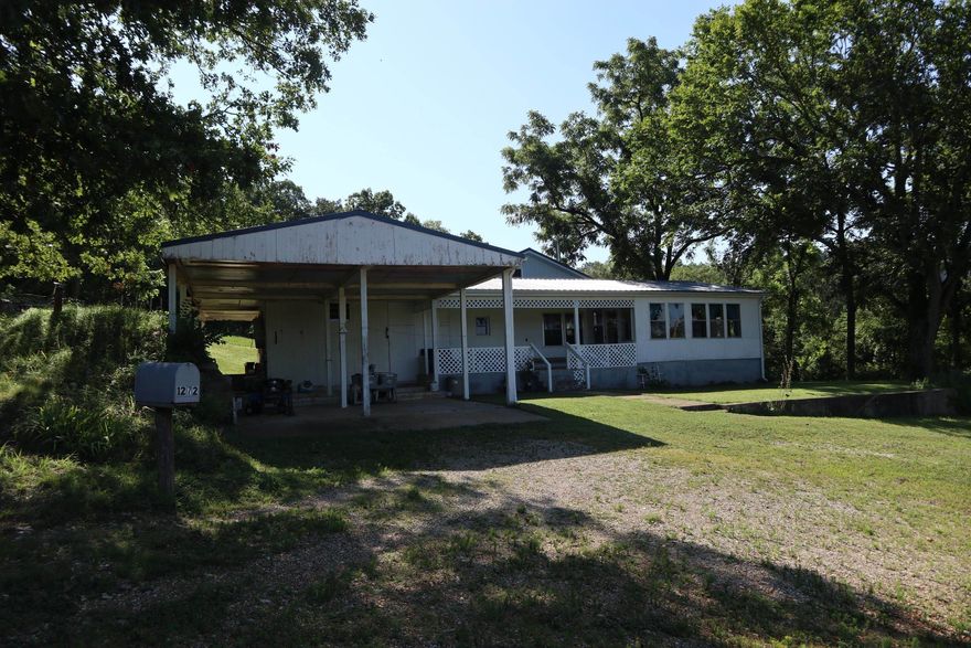 OFF GRID HOBBY FARM AND HOME FOR SALE STURKIE ARKANSAS Property is located at 1272 Sunrise Rd, Sturkie, AR. The property has 12.6 acres. The house has approx. 1,268 sq. ft. of living area with a total of 4 bedrooms, 2 baths. There is a loft area that has 2 of the bedrooms. There is a 2 car carport, large covered porches, storm cellar and a shaded yard.This property is currently off grid but does have electricity on site. It has a drilled well and septic system. The home consist of a mobile home that has been built on to. It has a newer metal roof. One of the additions was constructed in 2018. It has several outbuildings including a 21 x 28 storage building with lean to, a 15 x 16 storage shed, 14 x 20 barn with concrete floor and a 12 x16 open shed. It has a large garden area. There is approx. 4 acres of pasture with the balance in woods. It also has a great hilltop view. This property would be ideal for a few head of sheep, goats, horses or cattle. County road frontage and is only 1/4 to a public access on the Southfork River. The real estate taxes last year was $274.15. No appliances are included in the sale. The current owners have an air pump for well that is not included.