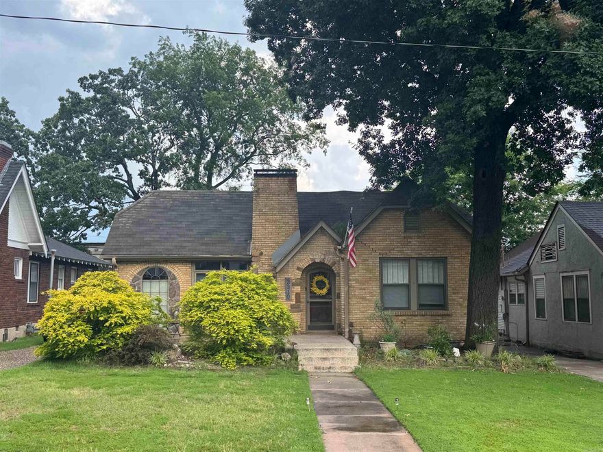 Charming Historic Bungalow in Park Hill   Nestled in the sought-after Park Hill neighborhood, this inviting 3-bedroom, 2-bathroom bungalow combines timeless vintage character with modern conveniences across 2,158?sq?ft on a generous 0.17-acre lot  Built in 1945, this one-story brick and vinyl-sided home retains original wood flooring and classic bungalow charm throughout. A chef’s kitchen offers granite countertops, stainless appliances, a gas cooktop with griddle, and a cozy hearth for gathering. Enjoy two ambient gas-log fireplaces in the den and hearth room for warmth and character  Spacious primary suite addition features 10' ceilings, custom built-ins, and a relaxing sitting area overlooking the backyard; adjacent is a luxurious bath with granite surfaces. Two additional bedrooms share a well-appointed full bath, all on the main level. French doors open from the kitchen to a large paved patio—one of three outdoor entertaining areas, including a deck and landscaped zones with lighting. Fully fenced lot provides privacy and space for play or gardening, with attractive level terrain. Detached 1-car garage and parking pad provide storage and guest convenience.