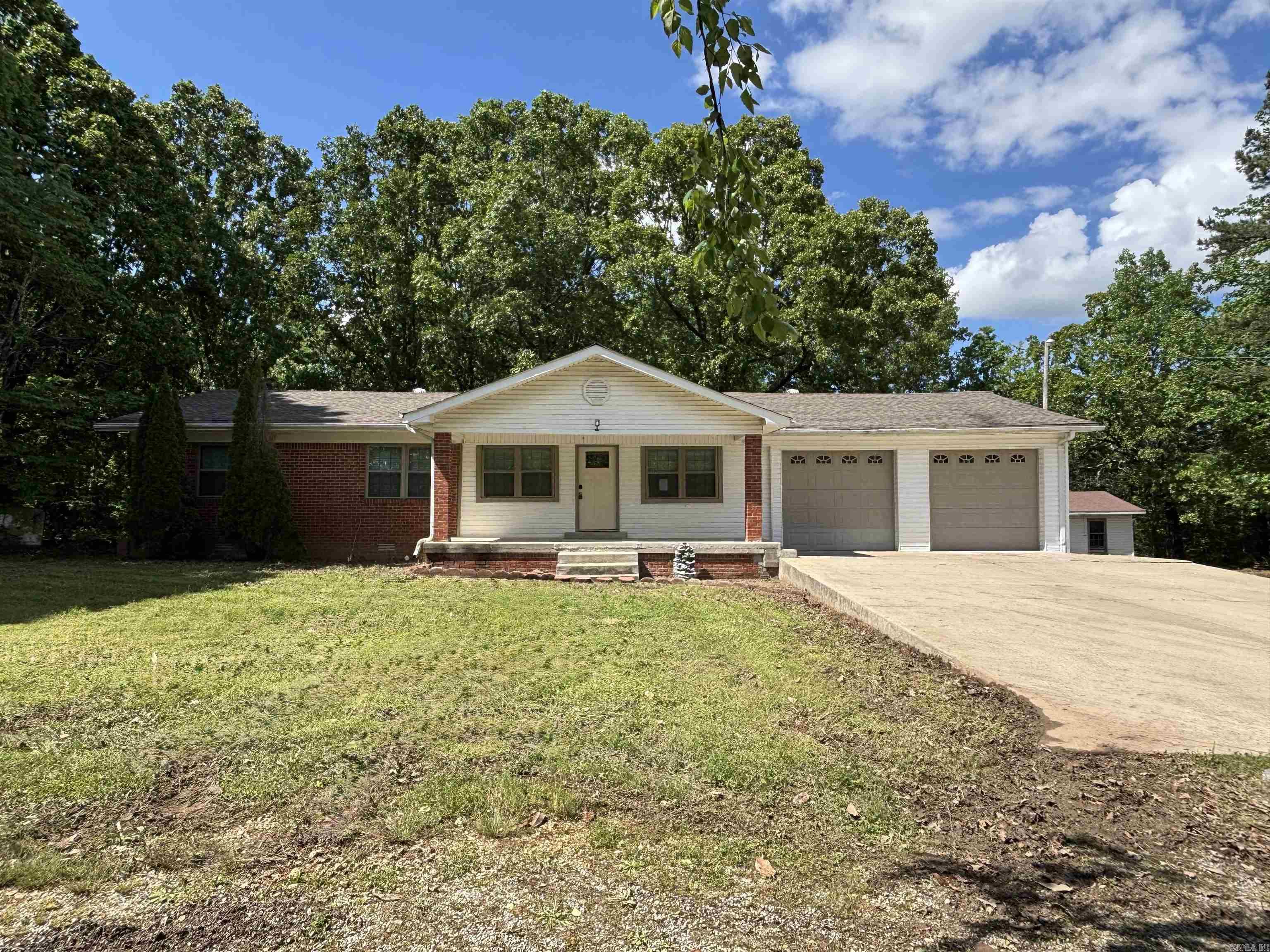 Enjoy the quiet of the country with this 3-bedroom, 2-bath home on 6.5(+/-) acres just outside the city limits. The open floor plan offers a spacious living area filled with natural light. The kitchen features plenty of counter space and abundant cabinetry, perfect for cooking and entertaining. The primary suite includes a private bath and walk-in closet, while two additional bedrooms and a full guest bath provide flexibility for family, guests, or a home office. Outdoors, the land is partially cleared with mature trees for shade and privacy. The roof was replaced in 2016 along with the garage door for the shop. The large detached shop with power is ideal for storage, hobbies, or a small business. Thereās plenty of room for animals, gardening, or enjoying wide open space. This property blends comfort and functionalityāideal for those seeking room to breathe, just a short drive from town.