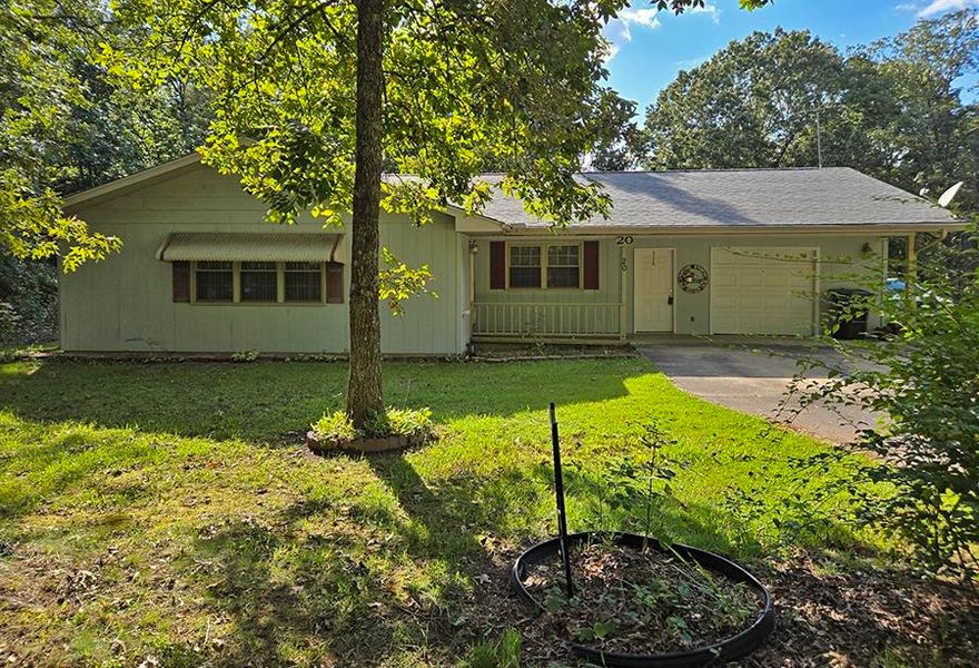 BEST PRICED HOME AVAILABLE IN THE VILLAGE! Come see for yourself... this 1991-built 2,100 square foot all-electric home is located an easy drive to the South Entrance. It sits on a level yard with no neighbor to one side, behind, or across the street. The home has a large 14x27 living room, 2 bedrooms, one large enough for king-size furniture and with a half bath and walk-in closet. There is a  full bath off the hallway for the guest bedroom and living room, plus a  3/4  bath off the full sized laundry room. The roomy kitchen has solid oak cabinets, dishwasher, and lots of countertop for food prep, and it opens to the 11x14 dining room. Windows were upgraded to energy-efficient vinyl double panes, with lots of natural lighting. The interior walls are drywall, and the the 6-inch exterior walls are wood-sided, with a front covered porch and rear covered deck perfect for bar-b-ques or relaxing. The central heat pump, extra large garage, 2021 architectural shingles, updated septic tank, and 16x20 detached shop that is wired for electricity all make this a great home for the budget minded family.  High speed internet is available in this location.  IN GOOD CONDITION AND MOVE-IN READY!