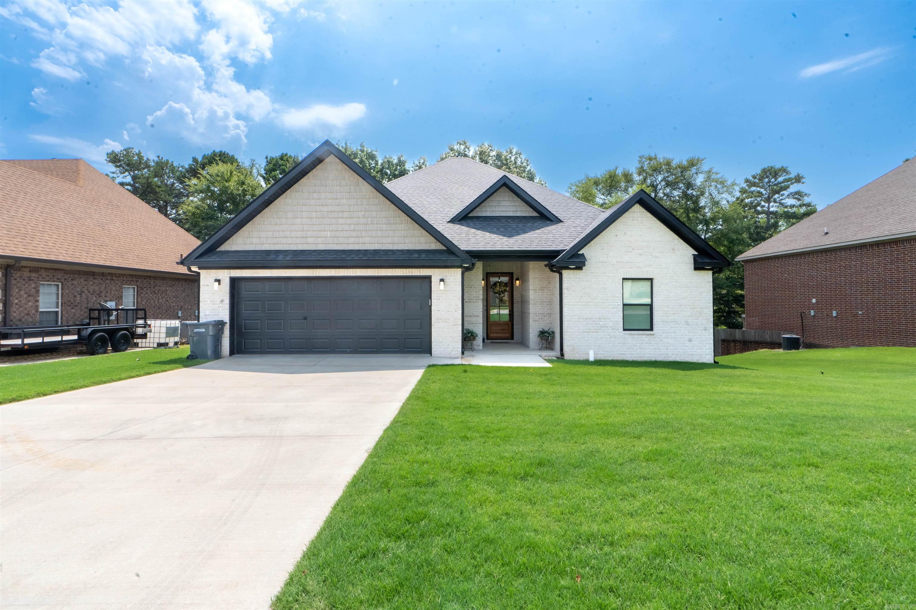 Almost New Construction, just over one year. Owner has New Commitment out of State, must move for New Job Opportunity. Nestled just moments away from the serene Craighead Forest Park, this stunning brick home is a dream come true for those seeking contemporary living in a prime location. Key Features: Spacious and Stylish: Soar with the 10ft ceilings, adding an airy, grand feel to every room. Revel in preparing culinary delights in this kitchen, complete with granite countertops and stainless steel appliances. Luxury meets Comfort: Three cozy bedrooms and two elegant bathrooms, each designed with sophistication in mind. Modern Open Concept: Flow seamlessly from one space to another in an open, inviting layout perfect for entertaining and daily life. Work and Relax: A dedicated office space for your productivity needs, coupled with a serene, screened-in covered porch. Imagine enjoying your mornings and evenings overlooking your lush backyard, supported by stylish brick columns. Durable and Chic Flooring: Luxury vinyl plank flooring, combining durability with modern aesthetics. By the Way, did I mention the Electric Vehicle Charger in the Two car Garage.