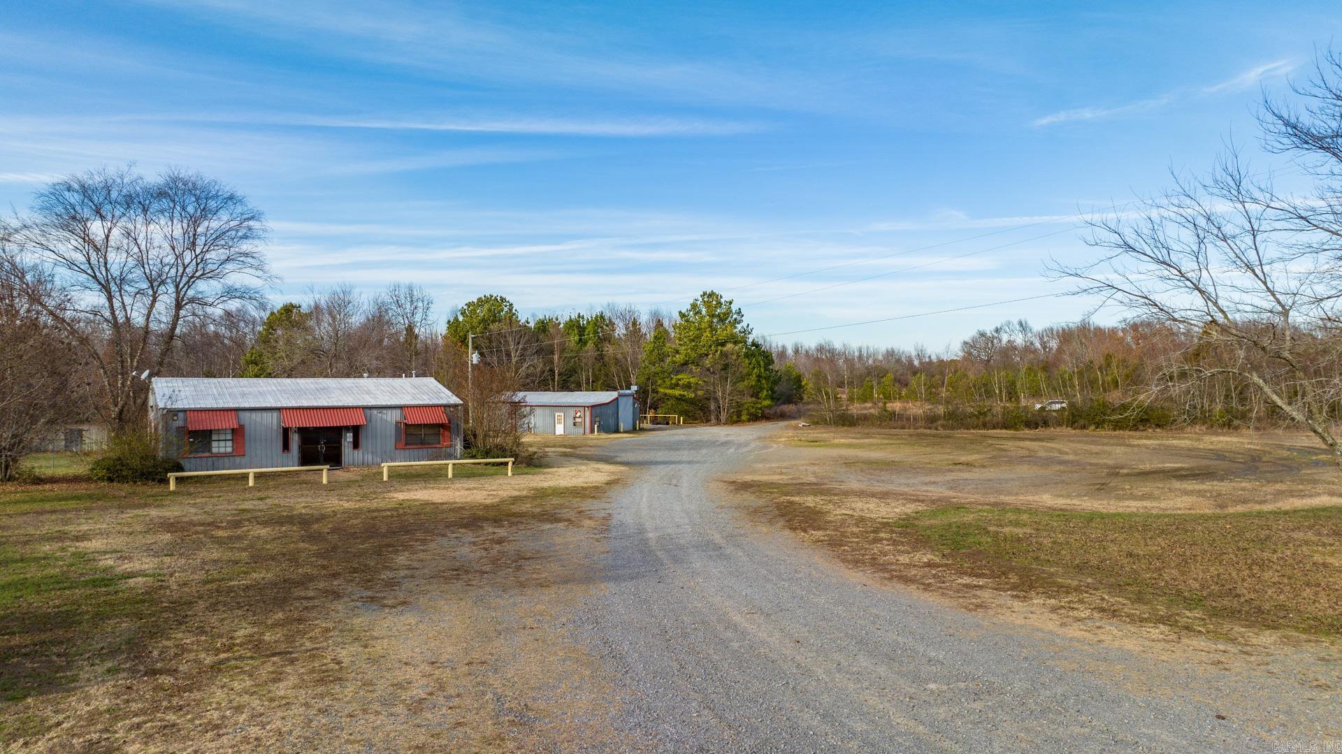 Amazing Investment opportunity. Great location on over 10 acres, mostly cleared with SHOP! Metal building used to be a daycare and drs office. Would be easy to remodel it and make it your new home. 3 bedrooms 1.5 bath, laundry, eat in kitchen and living area. Covered patio fenced in yard and outside storage building with large covered patio Heated and Cooled metal shop 1440 square feet with 15 baths, small kitchen, and two additional rooms. This property has tons of potential you don't want to miss it. Call me today for a personal viewing