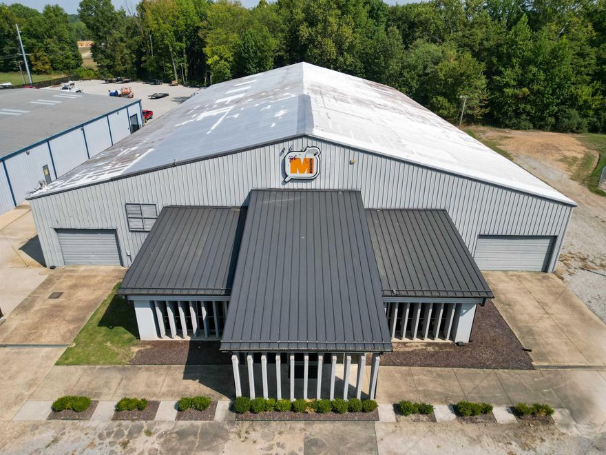 Conveniently located just 1 mile south of US 412 on Carroll Road, this versatile property offers an ideal mix of office, showroom, and warehouse space to meet a wide range of business needs.  The front of the building features a spacious central showroom and multiple offices, complete with ADA-compliant restrooms and breakrooms. The rear warehouse space boasts tall ceilings, providing excellent opportunities for racking and storage, as well as designated areas suitable for light manufacturing.  Loading and unloading are simplified with multiple access options: a sunken dock located next door, dual loading docks with leveling platforms, and a 14’ x 10’ front roll-up door.  This property combines functionality, accessibility, and adaptability—making it a strong fit for businesses seeking office, retail, distribution, warehouse space and manufacturing space in a central location.