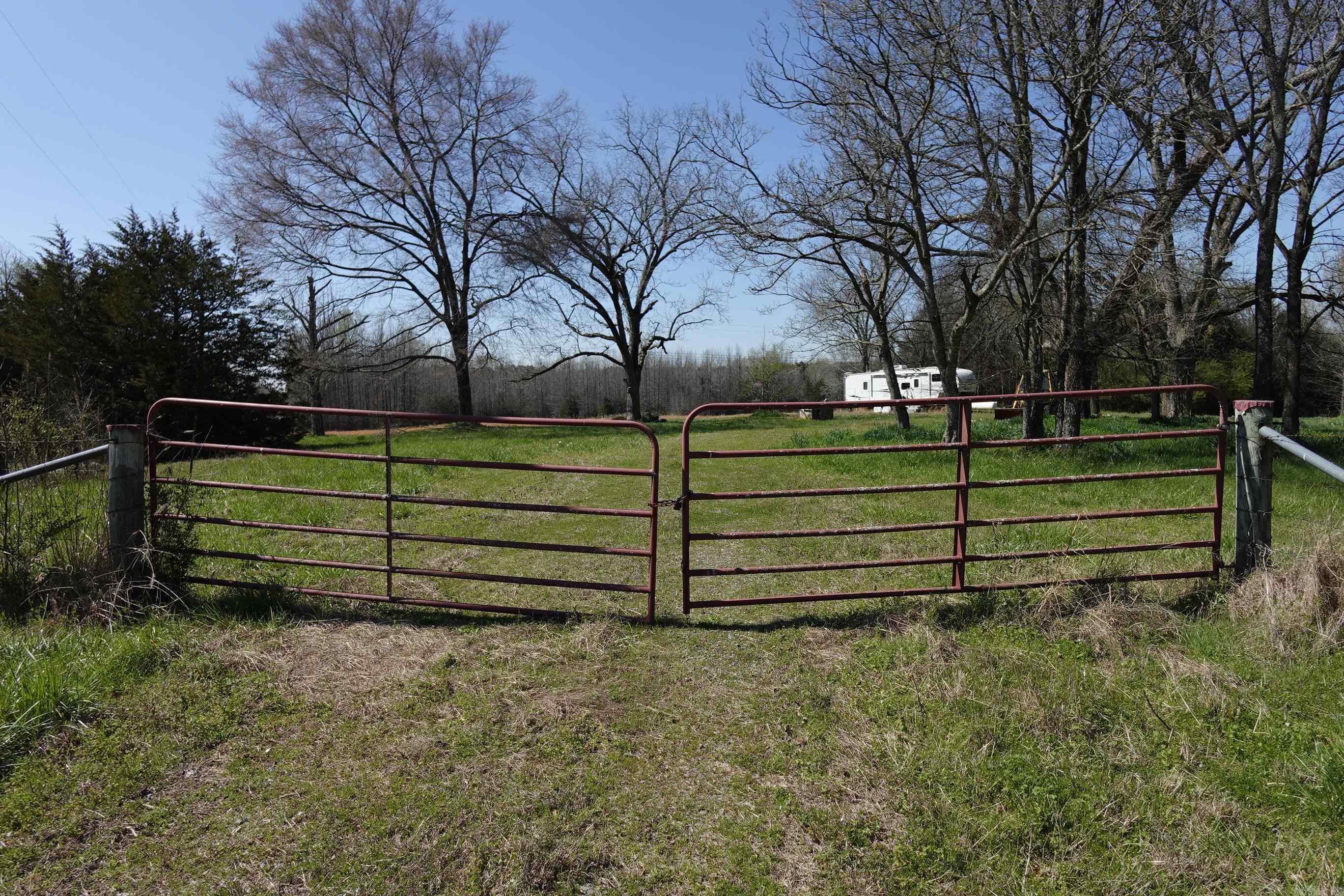 Great property for building dream home or great space to hunt lots of wildlife. There currently is a camper and backhoe on property that will convey. Camper seems to be in good shape but potential buyer needs to do their own due diligence. Seller doesn't know anything about the backhoe. There is electric hookup, butane tank and public water on property. Part of property is cleared in the front w/ dedicated driveway and gate off Newberry Rd. Wooded in the back and west side. Property is fenced. Property is on paved road right off of Hwy 287 and convenient to Holland, Hwy 64 & Hwy 65. To be sold AS IS. SEE REMARKS.