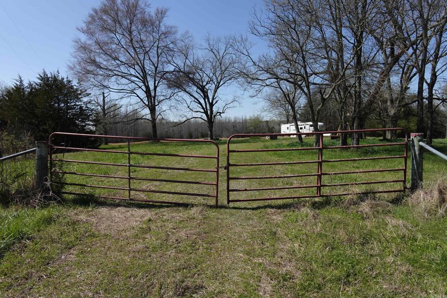 Great property for building dream home or great space to hunt lots of wildlife. There currently is a camper and backhoe on property that will convey. Camper seems to be in good shape but potential buyer needs to do their own due diligence. Seller doesn't know anything about the backhoe. There is electric hookup, butane tank and public water on property. Part of property is cleared in the front w/ dedicated driveway and gate off Newberry Rd. Wooded in the back and west side. Property is fenced.  Property is on paved road right off of Hwy 287 and convenient to Holland, Hwy 64 & Hwy 65. To be sold AS IS.  SEE REMARKS.