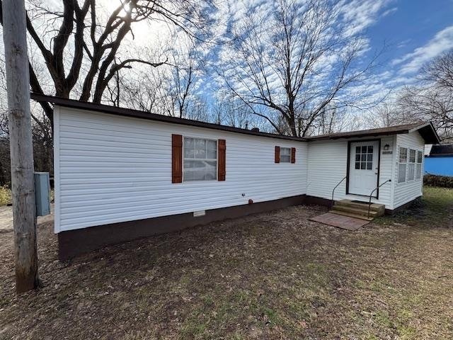 This lovely, well-maintained 2 bed/1.5 bath mobile home is move-in ready! The 14x58 home features 9x10 and 8x16 add-ons, plus a bonus room perfect for a 3rd bedroom or office. Enjoy a split system for heating and air in the main living area, with window units in the bedrooms and a gas space heater for backup. The large laundry area offers ample shelving, and the kitchen includes a pantry. A stove and propane tank are included. Relax in the spacious backyard! Conveniently located close to town. This would be a great income/investment property.