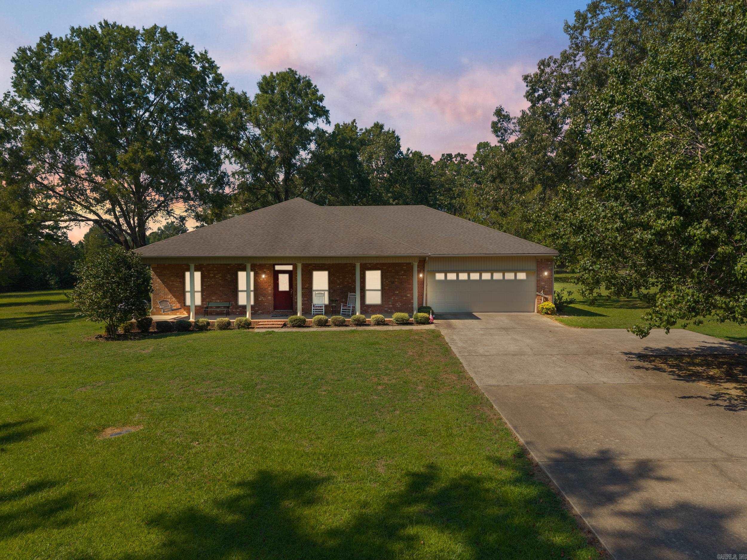 Immaculate 3BR, 2BA home with a shop on a spacious 1.28-acre lot near LRAFB, with an additional acre available for negotiation. This well-maintained home offers a prime central location with convenient access to both LRAFB and I-57. Step into a welcoming entryway that leads into a large family room featuring a cozy gas fireplace. The open-concept eat-in kitchen includes stainless steel appliances, a breakfast bar, and flows seamlessly into the dining area, which boasts beautiful hardwood floors. Tall 9-foot ceilings throughout add to the home's airy, open feel. All bedrooms offer generous walk-in closets, and the master suite features direct access to the back porch. The en-suite master bath is complete with a walk-in shower, dual vanities, and a relaxing corner jetted tub. Enjoy peaceful views from the large covered front and back porches overlooking the well-kept property. The attached 2-car garage offers additional storage, and the spacious shopāwith electricity and a garage doorāis perfect for hobbies, a workspace, or extra storage needs. Recent updates include a new HVAC system (2024) and a new hot water heater (2025). Don't miss your opportunity to make this your dream home!