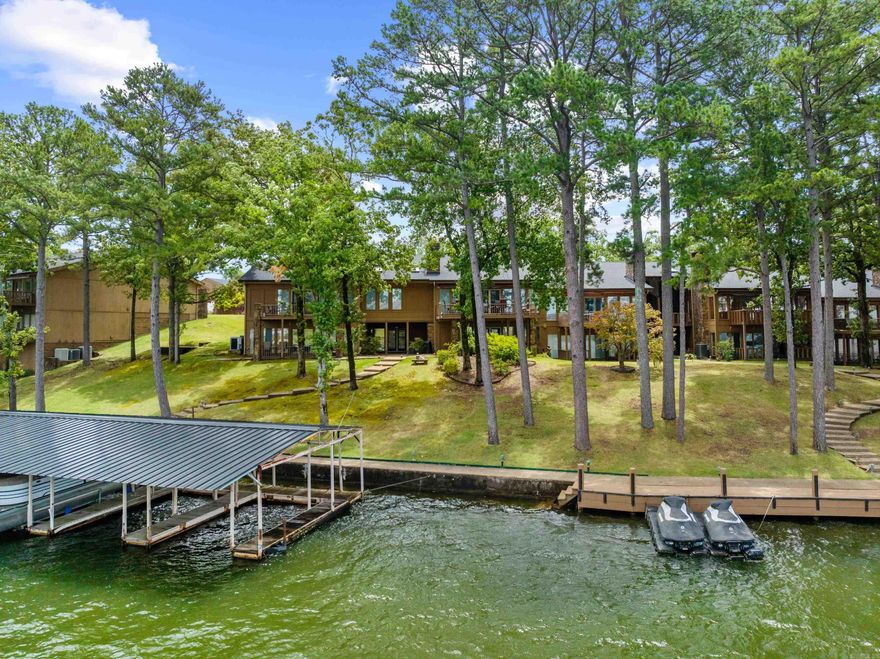 Located in the highly sought after Hamilton Pointe community, this exquisitely designed condo offers a rare opportunity for luxury lakefront living.  Designed to impress from the chef-inspired gourmet kitchen, featuring two of every appliance, to the serene spa-like primary suite and luxurious his and her bath for ultimate comfort and privacy.  Elegant finishes throughout this almost 7000 sqft masterpiece, boasting 5.5 bedrooms and 5 beautifully appointed bathrooms. This Lake Hamilton home offers a luxurious living experience like no other.  Enter into the main level featuring a spacious primary suite, living area and a large kitchen.  An elevator or beautiful staircase takes you to the Lower level which offers 4 bedrooms, 3 bathrooms, a second living area and a wet bar.  Features include ample storage an oversized laundry room and a full-house generator already connected for seamless backup power. Come experience this rare and unique property featuring three boat docks, four parking pads and a prime location in Hot Springs Arkansas.   Enjoy all the area has to offer and with a stunning main-channel view of Lake Hamilton.