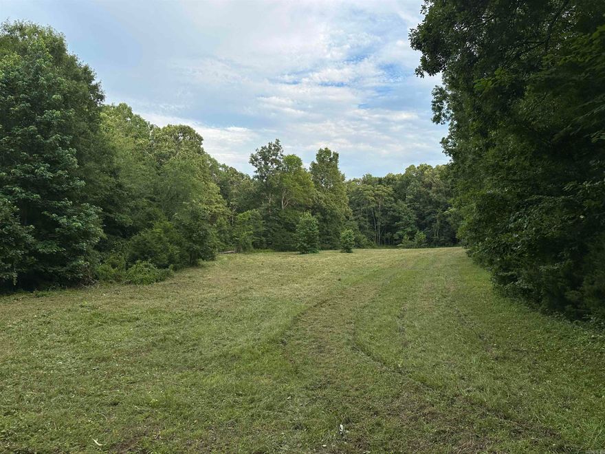 33 Acres m/l of hunting and recreational land near Searcy, AR   This versatile 33-acre m/l property is located just 10 minutes west of Searcy in the highly desirable Ozark Foothills. Whether you're dreaming of a private hunting retreat, a small hobby farm, or a peaceful country homesite, this property has the flexibility to suit your needs. Enjoy the hunting potential for deer, wild turkey, and small game.  Additional property highlights:   -33 acres m/l of mostly wooded land with a food plot  -Small field and pond  -Great for livestock, gardening, or recreation  -Improved trail system throughout – perfect for hiking, ATV, or hunting access   (agent owned)