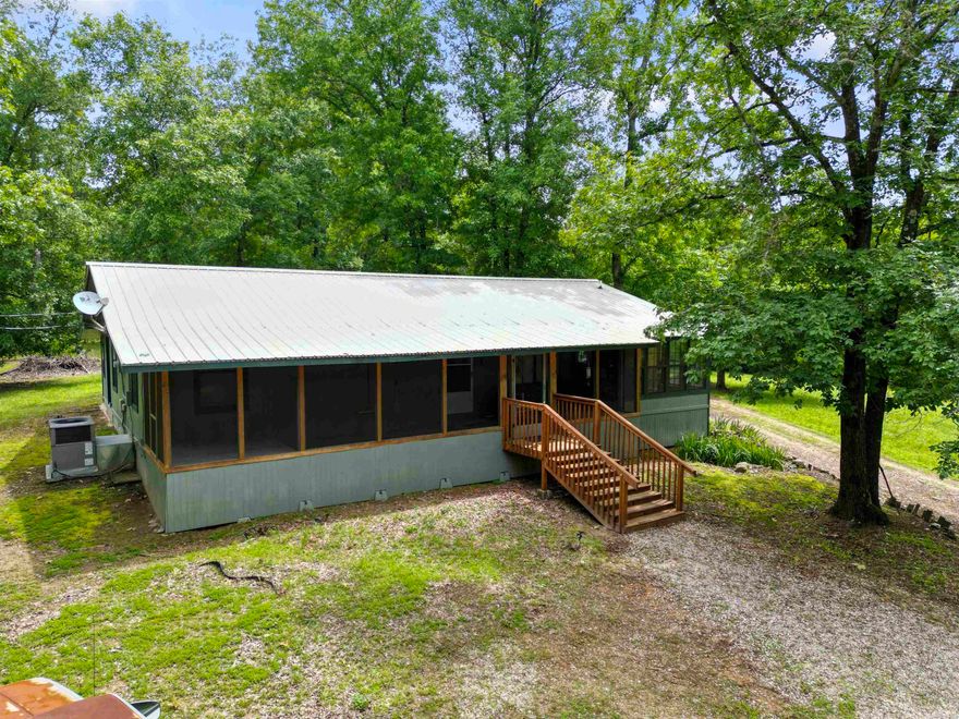 Private Retreat on 4.5 Acres! Tucked away on a quiet gravel road, this peaceful 2-bedroom, 2-bathroom home offers functionality mixed with seclusion. Set on nearly 4.5 acres of beautiful land teeming with wildlife and deer, it's an ideal getaway for nature lovers and hunters alike. A flexible floorplan includes a potential third bedroom with space already prepared for a window and closet, plus a spacious bonus room off the kitchen—perfect for a game room, hunting room, or hobby space. The large kitchen offers abundant countertop and cabinet space, ideal for cooking and entertaining, and opens into a dining area framed by windows that overlook your scenic surroundings. Enjoy peaceful mornings and evenings from the screened-in front porch, where you can relax and take in the quiet beauty of the land. A new metal roof (2021) offers durability and peace of mind, and the home includes a dedicated laundry area for convenience. Whether you're looking for a full-time residence or a private weekend escape, this property delivers space, tranquility, and privacy in a true natural setting. Great for primary residence or even a hunting lodge! Appraisal on file (11/2024). Call today!