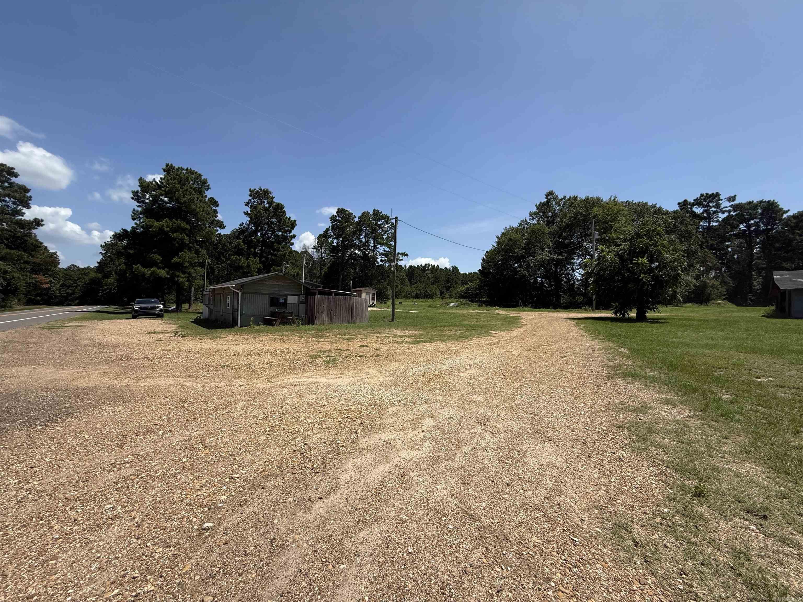 Many options for business or a great place to put a mobile home or build. The lot comes with a large shop and old burger shack. Utilities are available.