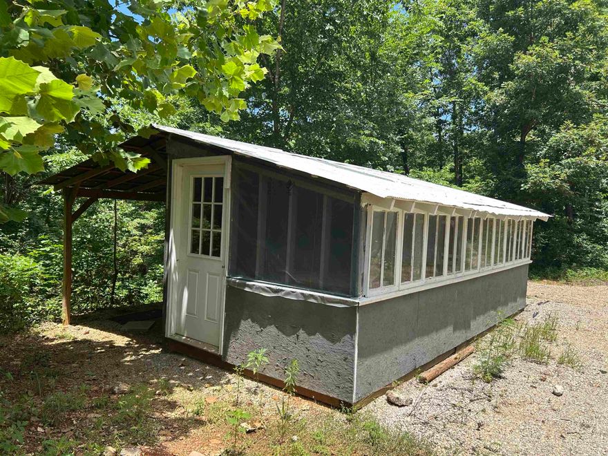 One-Room Cabin on 10 Acres± in the Beautiful Ozarks! This 10 acres±, property is mostly wooded and offers privacy, convenience, and great potential. The land has multiple buildings, including a one-room cabin with a covered lean-to, perfect for a rustic retreat or weekend getaway. A second structure—formerly used as a partial greenhouse—could easily be converted into a second cabin or guest quarters. The property also features a nice carport for your vehicle, boat, or outdoor gear, along with an additional storage building for tools or equipment. With community water, electric, high speed Internet and easy county road access, the essentials are already in place. Located just minutes from the Cold Spring access on the Spring River, and near Mammoth Spring State Park and the Mammoth Spring National Fish Hatchery. This property is ideal for outdoor lovers, campers, or anyone looking to create a peaceful hideaway in the Ozarks.