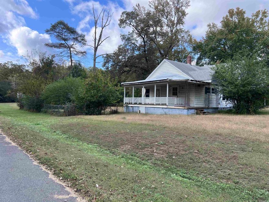 Check out this adorable and affordable home with a pretty southern front porch, nestled on a huge lot with a large fenced in yard and a small storage shed. Nice size kitchen and a spacious floor plan! Three bedroom 1 bath move in ready home but will need some TLS with minor repairs.     **** Utilities are not on and buyer will be responsible for turning them on for inspections.  Huge level lot next door available for an additional $25,000