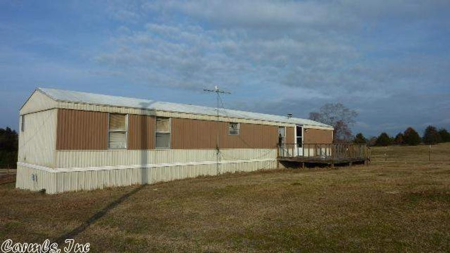 Fully fenced (for livestock) 10.12 acres of mobile home site and pasture land. Large pond on property protected by cedar trees. Acreage has rolling hills and has great views. Mobile home has a large deck attached. The underpinning is new as well as the air conditioning and duct work. Newer water heater. Propane tank for heat. Well on property not hooked up. Mineral rights on 10.12 acres to convey. Additional acreage available. (See agent remarks.)