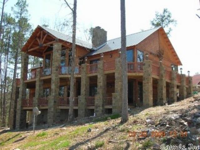 3 additional bedrooms with 2 baths. The detached 3 car garage with stained concrete floors is heated and cooled with a walk-up staircase with floored storage above.
