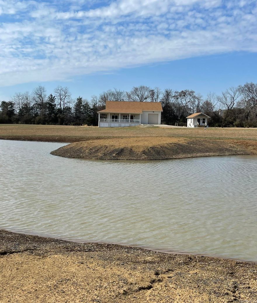 This is an absolute dream house situated on 11.10 acres. It features a charming guest house that includes a full bath and is both heated and cooled. Enjoy your morning coffee on the spacious front porch while taking in the stunning sunrise and breathtaking pond view. You can store your zero-turn lawn mower in the small barn located near the house.   The main house, completed in early 2025, showcases beautiful Arkansas red oak hardwood floors and elegant marble kitchen countertops imported from Greece top off the custom cabinets. Relax in the lovely claw-foot tub after a long day. The single garage door is tall enough to accommodate a horse trailer or a large truck. There is a large bonus room upstairs, finished with heat and air, just nees painting and a stair railing.    The is enough pasture for a small farm operation for horses or livestock.      Living in this rural area offers the tranquility of farm life while still being conveniently located just a mile from local amenities. As you arrive home at night, you'll be greeted by the custom-designed art under the porch, beautifully illuminated from behind, adding a whimsical charm to this enchanting home.