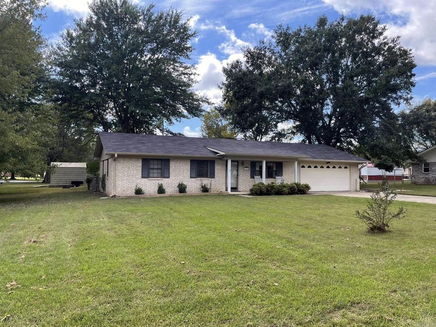 Beautifully updated 3-bedroom, 2-bath brick home on a large lot with mature shade trees in a desirable subdivision! This property has been thoughtfully improved with a NEW roof & NEW CH/A unit (2024). Inside, you’ll find a bright kitchen with updated appliances (2022), plus a NEW refrigerator (2024). The laundry room is heated/cooled and features a convenient sink, extra storage, and backyard access. Flooring was replaced in 2022, giving the home a fresh, modern feel. Enjoy outdoor living on the spacious covered patio overlooking a fenced backyard with extra landscaping and a new sidewalk leading to the back. Mountain views in the front yard and a grassy meadow with the most beautiful cedar trees in the back. The oversized garage includes a storage room. Metal storage building adds more convenient storage for mowers and tools. Move-in ready with all the right updates—this one checks every box!