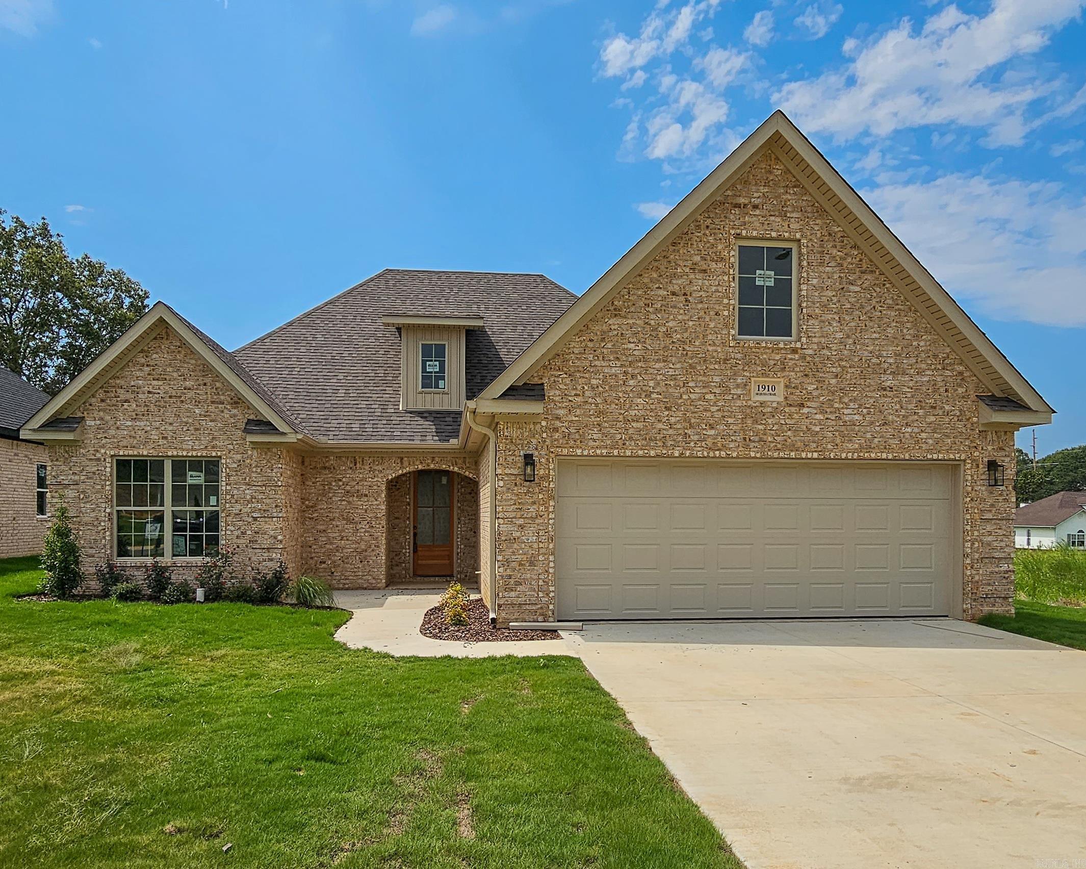 Modern warmth meets thoughtful design in this open-concept home. The cozy fireplace anchors the great room, while a wood-stained kitchen island adds charm and creates subtle separation. Quartz countertops offer upscale appeal throughout. Enjoy a spa-like retreat in the primary suite with custom tile shower, soaking tub, double vanities, and a spacious walk-in closet. Two guest rooms and a stylish bath sit privately across the home, with a mudroom and laundry adding everyday convenience. Upstairs, a fourth bedroom with ensuite bath and large closet provides flexible space for guests or home office needs.