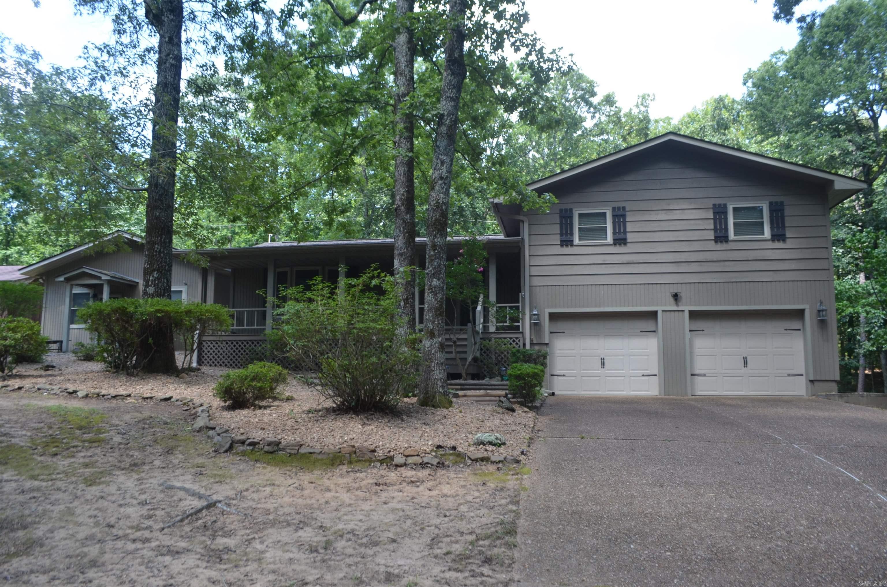 Updated home with separate living quarters located near the south shore of Greers Ferry Lake, community lake access, property has a 3 bed room 2 bath main residence of 1600 sf with large private back deck to gather and grill on, stone fireplace with gas logs that serves as the centerpiece of the great room. Kitchen was updated in 2024 with granite counter tops and new stainless appliances, living quarters is approximately 805 sf and could serve as in-law quarters or bunkhouse, game room, home office or man cave. Complete with its own entrance, kitchen, large bedroom & full bathroom, home has a kohler whole house generator and area for small garden, all on just under 3 acres