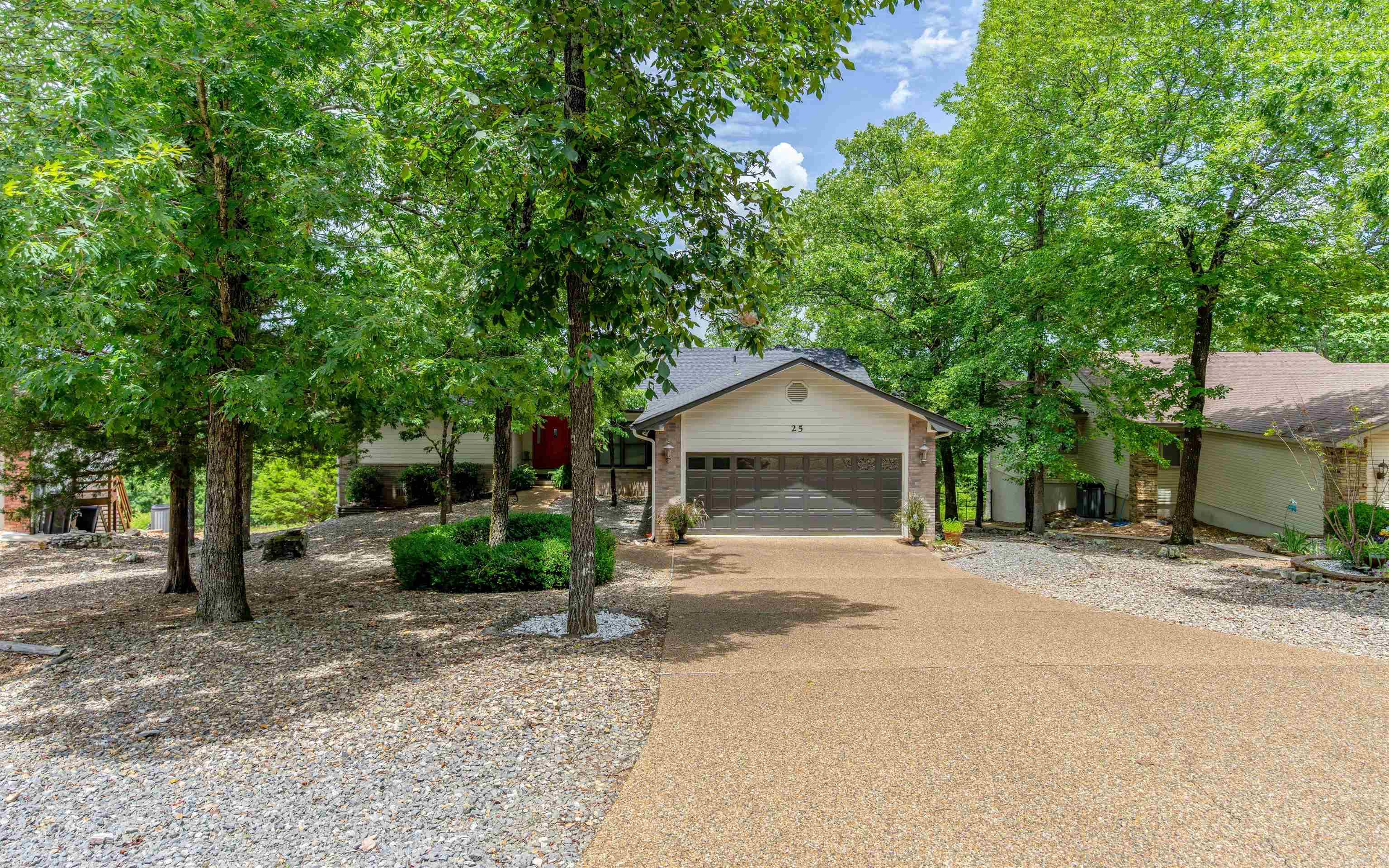 Enjoy sweeping vista views from this beautifully updated two-level home, offering 2,476 square feet of spacious living. With 3 bedrooms and 3 bathrooms, this home combines modern upgrades with functional living spaces. The main level features a large living room with fireplace; convenient main-level laundry room with laundry sink; completely remodeled kitchen and dining area--ideal for entertaining; spacious and updated master suite with amazing remodeled bathroom; and guest bedroom. The lower level has a third bedroom and full bath; office/hobby room; and bonus storage room with overhead garage door--perfect for a workshop, or extra storage. Additional updates include a new roof and leaf guard system in 2024; freshly painted exterior in 2024; luxury vinyl plank (LVP) flooring on main level; and lower level stained concrete. Come see all that this gorgeous move-in ready home has to offer! Some furnishings available for sale separately.