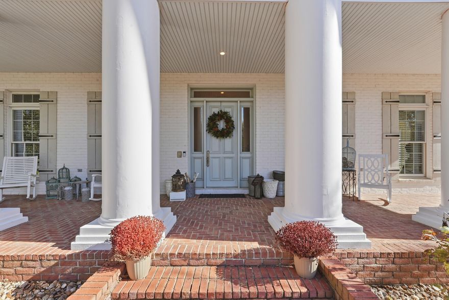 Discover resort-style living in this beautifully curated two-story home, surrounded by mature hardwoods and fragrant David Austin English roses. Multiple covered porches, including a charming sleeping porch with a custom bed swing, offer inviting spaces to relax and unwind. The backyard feels like a private resort, featuring an oversized heated saltwater pool with a shallow-end bench, a putting green, and a shady hammock that is perfect for afternoon reading. Inside, the kitchen is a true showpiece with Fantasy Brown quartzite countertops, a herringbone brick floor, and premium appliances. A double-sided wood-burning fireplace adds warmth and character to two elegant living spaces. The primary suite opens to its own private balcony overlooking the pool. For ultimate relaxation, enjoy the custom Jason hydrotherapy tub, offering a spa-like experience at home. A downstairs bedroom, full bathroom, and additional living area with a wet bar provide exceptional flexibility and could easily serve as a luxurious in-law suite. Located just steps from the golf cart path to the Conway Country Club, this home seamlessly blends timeless sophistication, upscale comfort, and everyday convenience.
