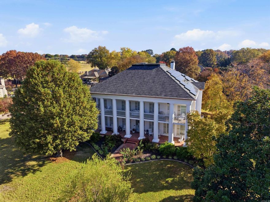 Discover sophisticated luxury in this beautifully curated two-story home, surrounded by mature hardwoods & fragrant David Austin English roses. Multiple covered porches—including a charming sleeping porch with a custom bed-swing—create inviting spaces to relax. The backyard feels like a private resort with an oversized heated saltwater pool featuring a shallow-end bench, putting green, and a shady hammock perfect for afternoon reading. Inside, the kitchen is a true standout with Fantasy Brown quartzite countertops, herringbone brick floor, and premium appliances. A double-sided wood-burning fireplace warms two elegant living spaces. The primary suite enjoys its own private covered porch, offering a serene retreat, & for ultimate relaxation, unwind in the custom Jason hydrotherapy tub—your personal spa at home. A downstairs bedroom, full bathroom, & additional living area with an existing wet bar provide valuable flexibility & could easily become a luxurious in-law quarters. Located just steps from the golf cart path to the Conway Country Club & within walking distance of the Tucker Creek trail, this home blends timeless sophistication & upscale comfort with everyday convenience.