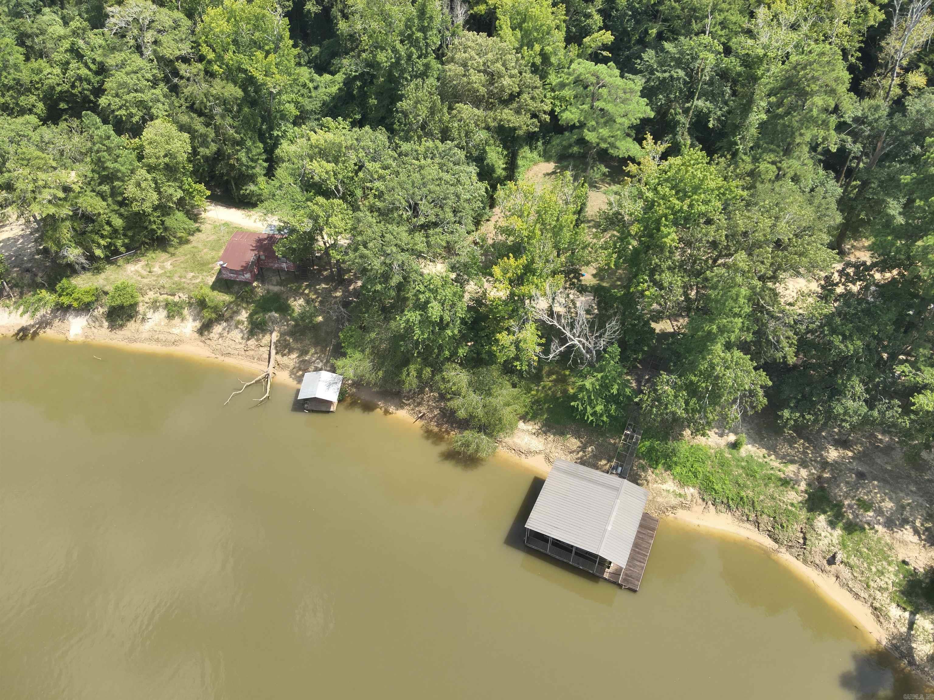 he ‘Careyville Tract’ is a ±189.43-acre tract located in the northeastern part of Union County, AR, about 6 miles from Moro Bay State Park and less than 40 miles from El Dorado. This unique tract is located on the Ouachita River with over ½ mile of river frontage! Careyville Road, a Union County Road, provides the property providing excellent access. Typical rural utilities (electrical & water, and county services) are available along the road. This property is adjacent to Felsenthal National Wildlife Refuge. The tract has numerous woods roads throughout the property for your off-roading enjoyment! The tract has about 37 acres of upland pine, about 25 acres of open water and cypress, and about 124 acres are mature bottomland hardwood. There are also two river lots with a river camp on one lot and two boats docks with stairway access to each! This property provides a secluded place close to town on the Ouachita River, another location to build a river camp, and a place to hunt and fish, do not miss out on the ‘Careyville Tract’!