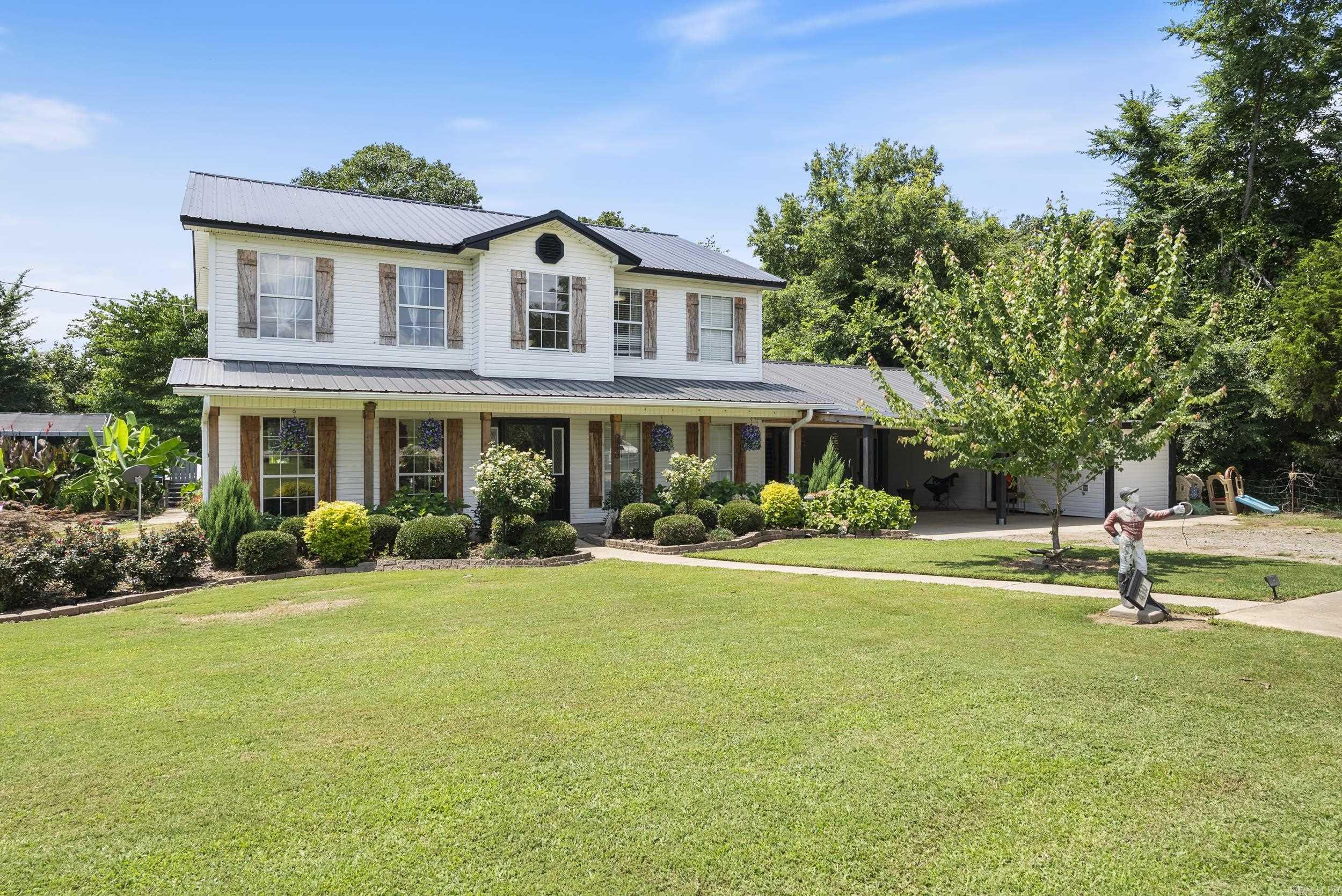 Beautiful 2-acre property with mature trees, open green space, and a sparkling swimming poolāperfect for relaxing or entertaining. This well-kept two-story home offers 3 bedrooms, 2.5 baths, formal dining, and a spacious, light-filled living area. The primary suite features a walk-in closet and private bath. Enjoy classic curb appeal with a covered front porch and durable metal roof. The property includes multiple electric meters serving the detached shop, finished tiny house, and a framed, unfinished structure with plumbing rough-ināoffering potential for an ADU, guest space, or workshop. Convenient location with easy access to town, schools, and major highways.