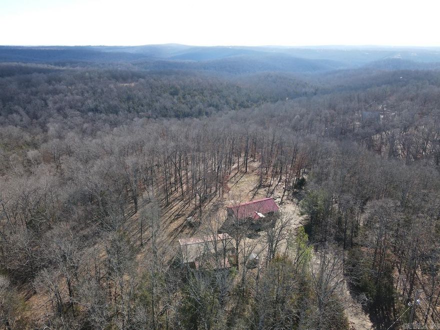 What a beautifully managed hunting tract located just minutes north of the wonderful community of Mountain Home, AR. This property is loaded with character, infrastructure, a hunting cabin, years of whitetail deer and turkey management, and borders a section of Norfork Lake! The land is situated bordering a paved county road with phenomenal and easy access. As you enter, tucked just back out of sight from the road, is a quaint, updated, and very adequate 3-bedroom cabin. The cabin also has a full bathroom, laundry, kitchen, spacious living room, two large decks, fresh exterior paint, and a metal roof. The cabin has also been partially renovated and updated. A large yard is complemented by huge, towering oak trees and will surely be the ideal hangout spot for you, your family, and guests as you enjoy your new outdoor adventure playground! Next to the cabin is a large metal shop with an overhead garage door, electricity, and a concrete floor with ample storage for your tools and equipment. All of this infrastructure is strategically situated at the entrance of the property to avoid disturbing the wildlife. Navigating the awesome spread are miles of ATV trails.