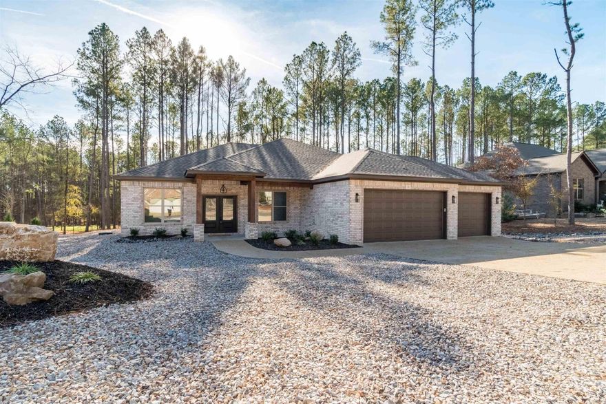 34 Victoria Lane — a thoughtfully crafted, single-level new build by Pantheon Construction, LLC. Nestled on a level .39-acre lot in Hot Springs Village, this home offers effortless one-level living and an open floor plan filled with natural light from expansive windows, creating a welcoming feel throughout. The heart of the home features a warm and stylish living space centered around a modern fireplace, perfect for cozy evenings. The kitchen is a dream for cooks and entertainers alike, complete with a generous walk-in pantry and plenty of counter space for meal prep and gatherings. Relax in the spacious primary suite, designed as a true retreat with an oversized walk-in closet. Outside, enjoy low-maintenance landscaping and a peaceful setting, highlighted by a large covered patio—ideal for grilling, relaxing, and hosting friends and family. This home boasts a 3-car garage and a Rheem tankless water heater. Conveniently located near the East Gate off DeSoto Blvd, you’re just moments from top golfing amenities including the Granada, Isabella, and Diamante Golf Courses and Grills—making this a golfer’s paradise.