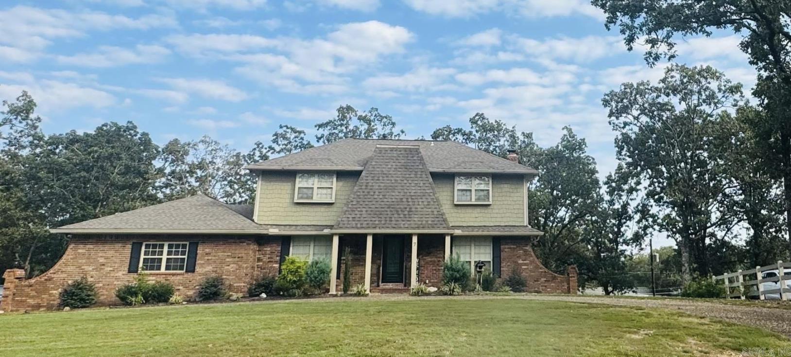 Discover this beautiful 4-bedroom, 3-bath home tucked away in a quiet cul-de-sac in the highly sought-after Indian Hills subdivision of North Little Rock. With nearly 2,800 sq. ft. of living space, this home offers both space and comfort. Inside, you’ll find a welcoming layout with hardwood and tile floors, spacious living and dining areas, and a cozy fireplace that creates a perfect gathering spot. The main-level primary suite offers convenience, while three additional bedrooms upstairs provide plenty of room for family, guests, or office space. The exterior features wood siding accented with stone, giving timeless curb appeal. Two decks extend your living space outdoors, overlooking a backyard with a beautiful retaining wall and peaceful lake views. Whether you’re entertaining friends or enjoying a quiet evening, the setting is designed for relaxation. A circle drive and two-car garage provide ample parking. Conveniently located near shopping, dining, and schools, yet nestled in a private cul-de-sac, this home combines charm, function, and a location that’s hard to beat.