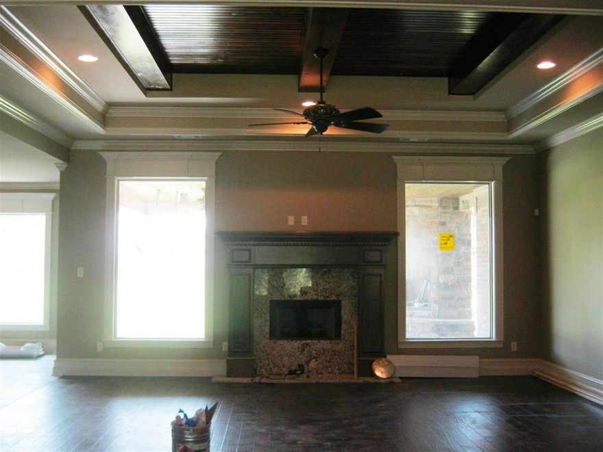 This home faces the lake. Extra landscaping, side load 3 car garage. Eight foot doors through out . Large great room, has office and bonus room > Large covered back porch with fireplace. Granite and tile in all wet areas.  Hardwood in main living areas.  Master closet goes into laundry room