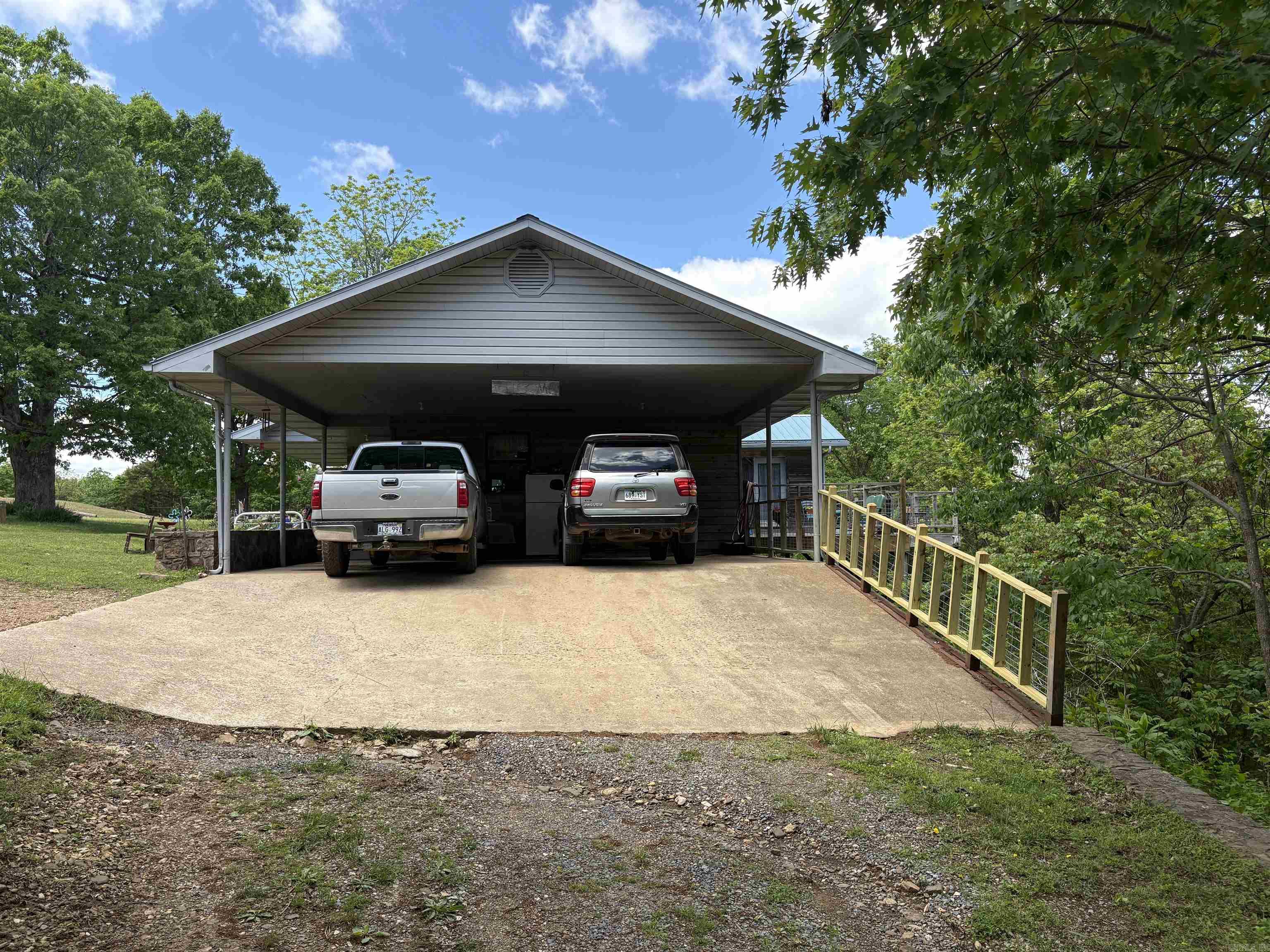 Discover country living at its finest with this stunning 26-acre property, perfect for nature lovers and outdoor enthusiasts. Ideal for hunting, the land is rich with wildlife and includes 7 hotwire-fenced acres ready for livestock, complete with a serene pond. Enjoy breathtaking mountain views from the spacious back deck, or relax in the master suite featuring a jetted tub. Perfect for family get togethers with a living room featuring a large custom rock fireplace. A massive 50x60 ft. metal shop with a concrete foundation offers endless possibilities for work or hobbies, and a covered 2-car carport adds convenient, weather-protected parking. This one-of-a-kind property blends comfort, functionality, and natural beauty—don't miss your chance to make it yours.