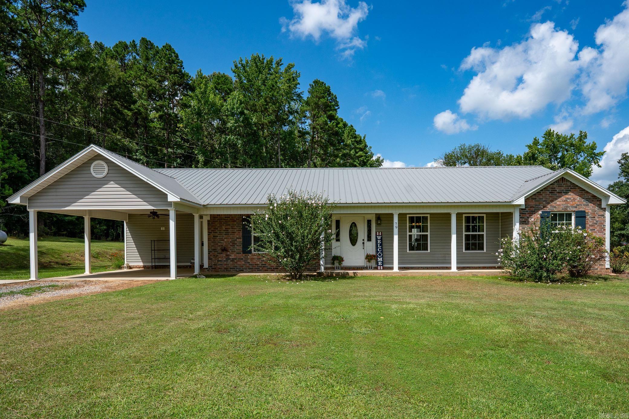 Wonderful 4-bedroom, 2.5-bath home nestled on a private 2.86-acre lot with shop & pool. This open floor plan features a spacious living room with a cozy fireplace, a large dining area & a beautiful kitchen. The kitchen boasts granite countertops, stainless steel appliances, gas stove, center island & ample cabinet space. The large primary suite with en-suite bathroom features double sinks, great storage, granite countertops, jetted tub, walk-in shower & an oversized walk-in closet. Three additional guest bedrooms share a hall bath. Large laundry room & half bath. There is a 30x30 shop with a covered grill area overlooking a 30-foot above-ground pool. On the opposite side of the shop, a covered storage area. Also includes a sink and countertop for added convenience. The peaceful, tree-lined property offers privacy and tranquility with a nearby creek.
